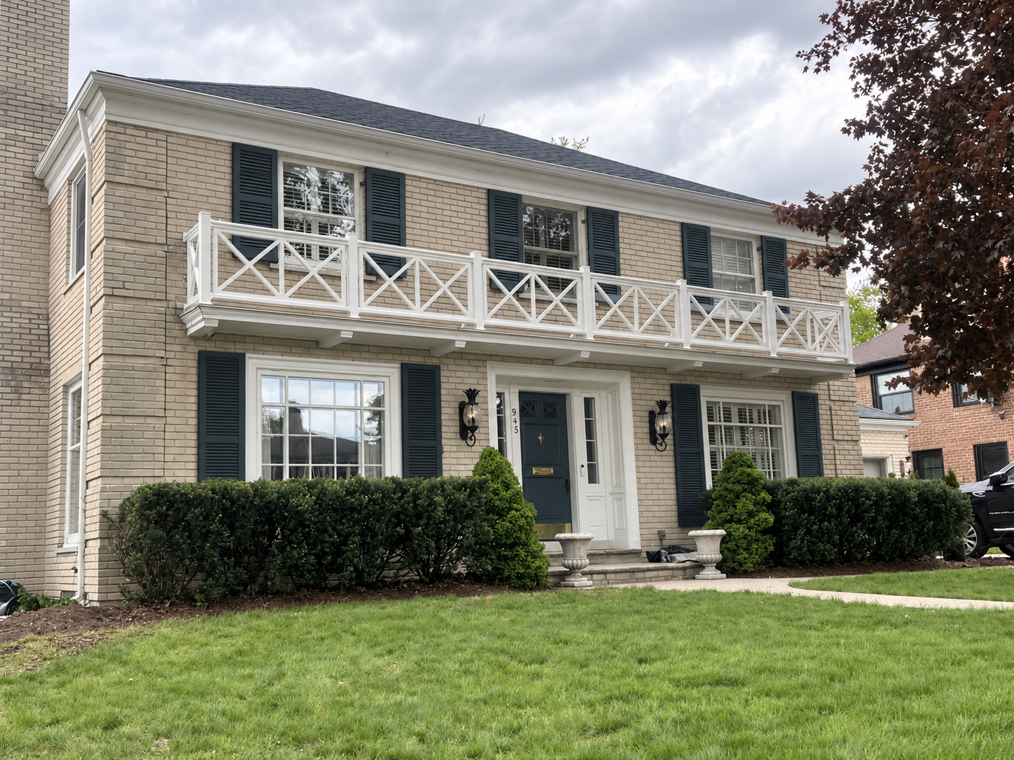 AFTER - Fully custom-fabricated balcony railing, new shutters and paint