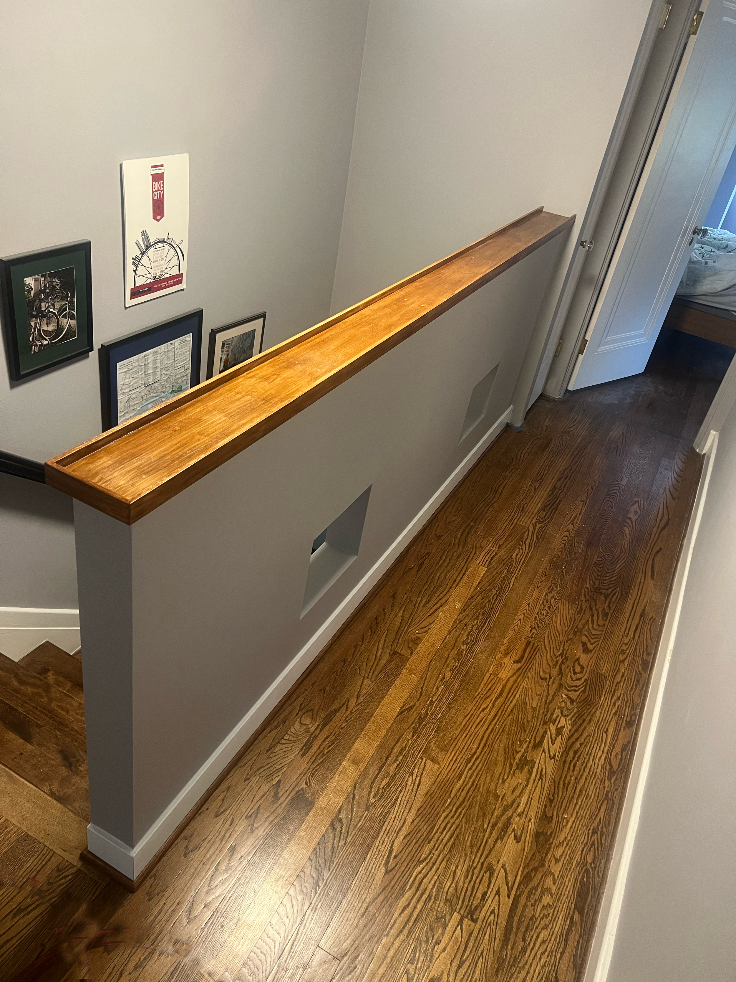 AFTER - Pony wall with custom "cat windows" and red oak cap. And yes, her cats crawl up into the windows and peer down.