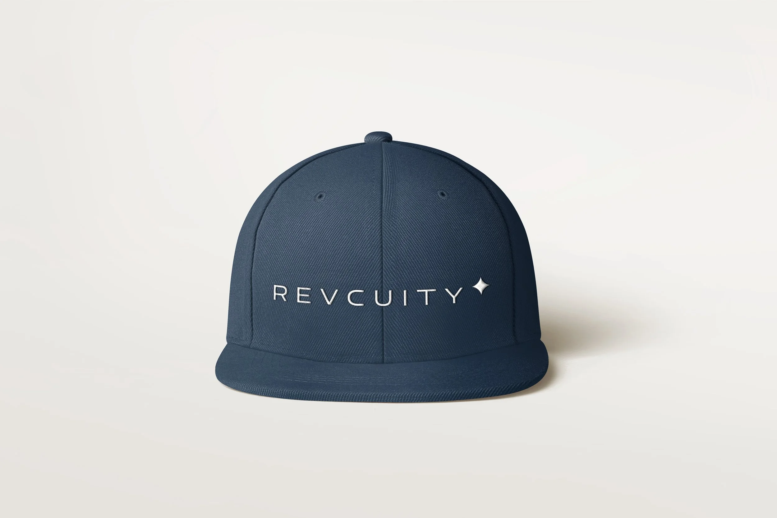 Navy blue cap with the word 'REVCUITY' and a small star emblem in white embroidered on the front, against a plain light background.