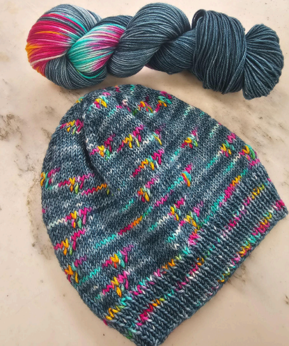 Knit hat developed by Joann for Yesterday's Ewes to be made with Main Street Dyehouse Octo Eight Ply assigned pooling yarn