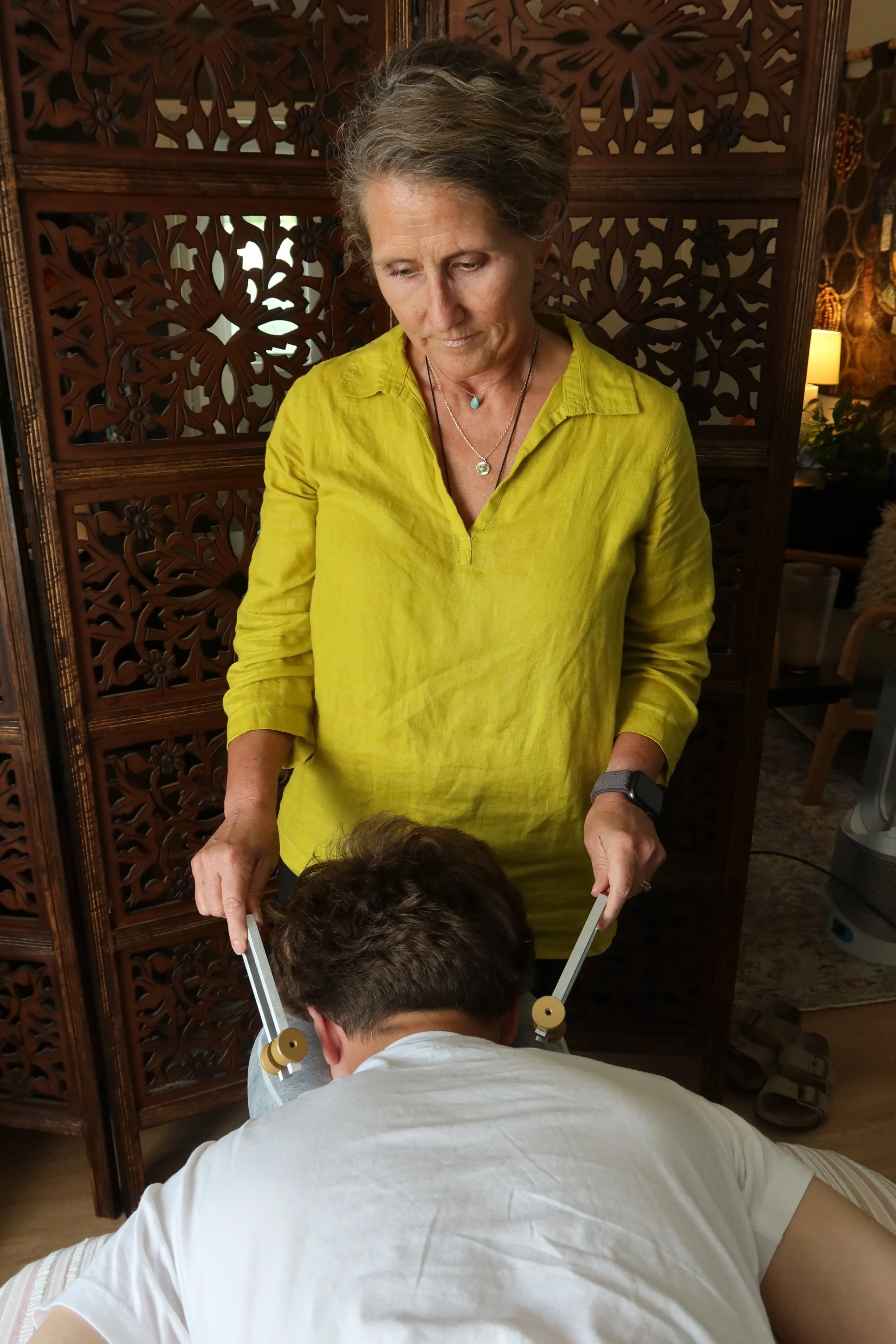 A woman performs acutonics.