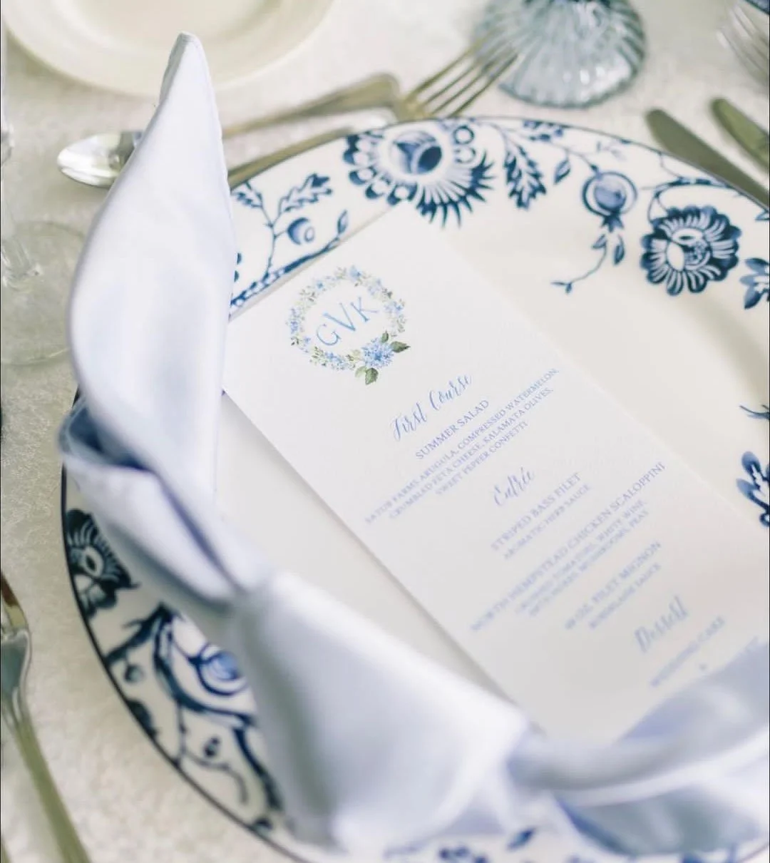 Blue Hydrangea watercolor crest by Tying the Knots Studio featured on a wedding reception menu.