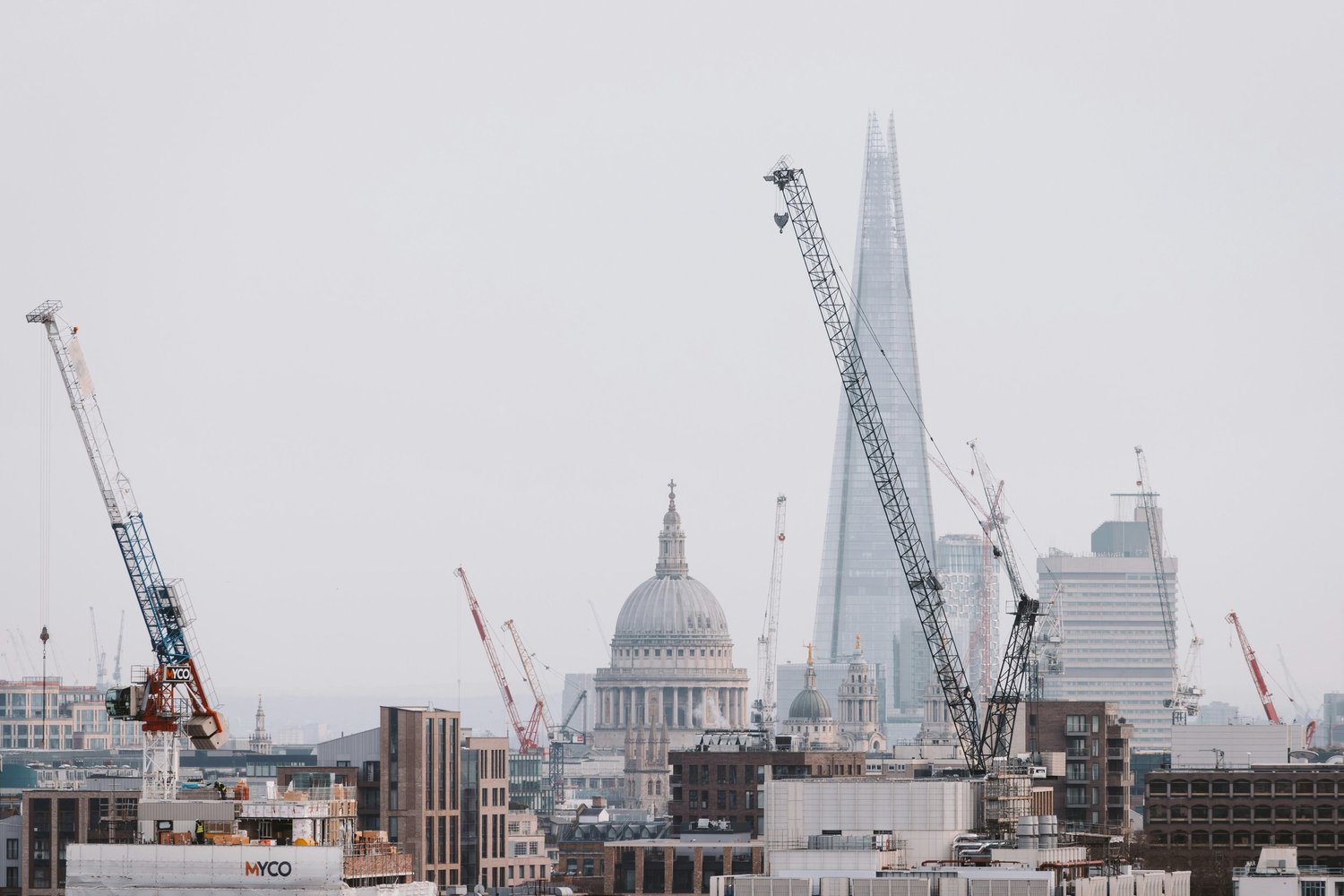 London skyline with cranes, St Paul's Cathedral and The Shard