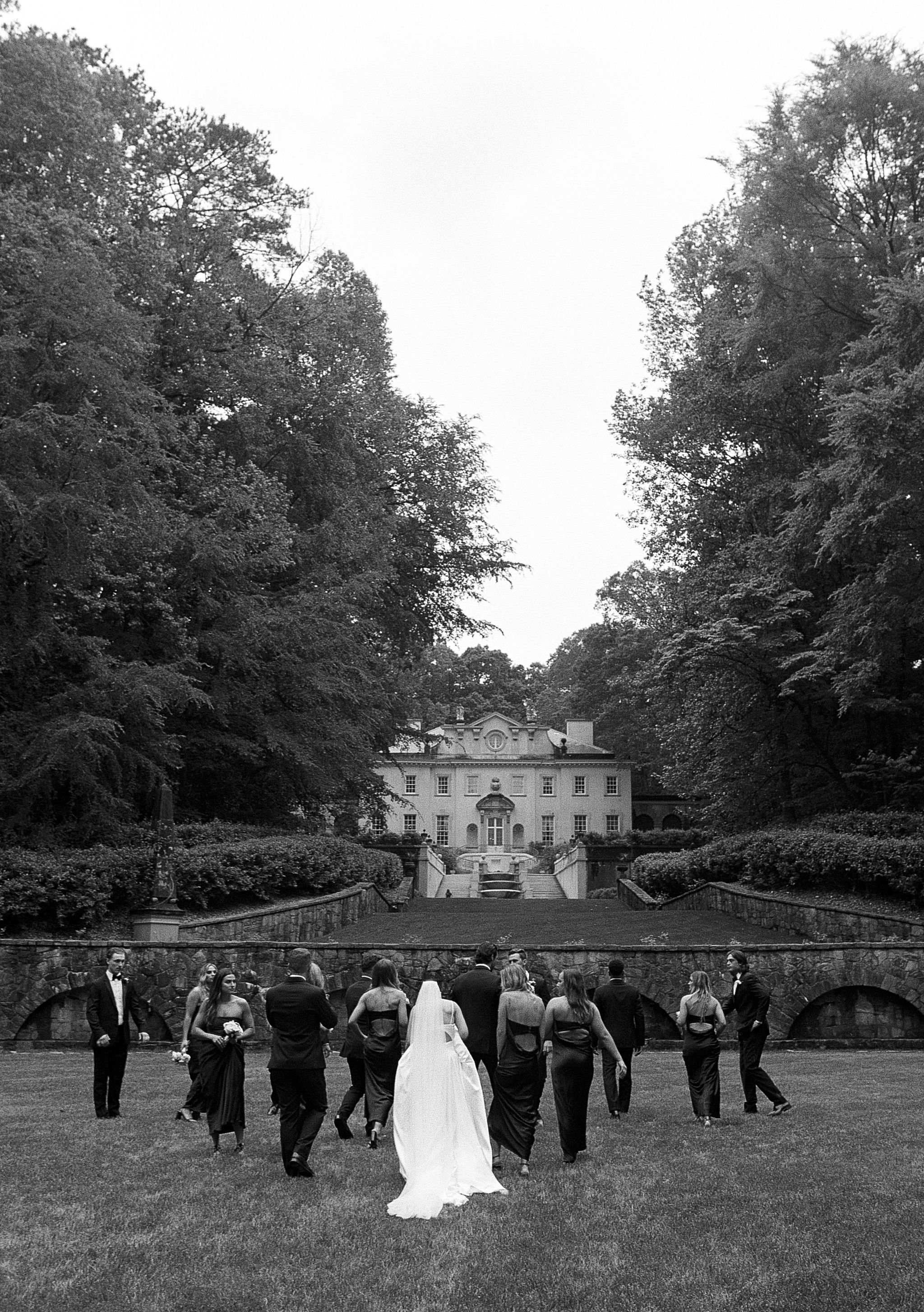 Bride and groom walking through Swan House gardens in Atlanta Georgia during romantic wedding portraits