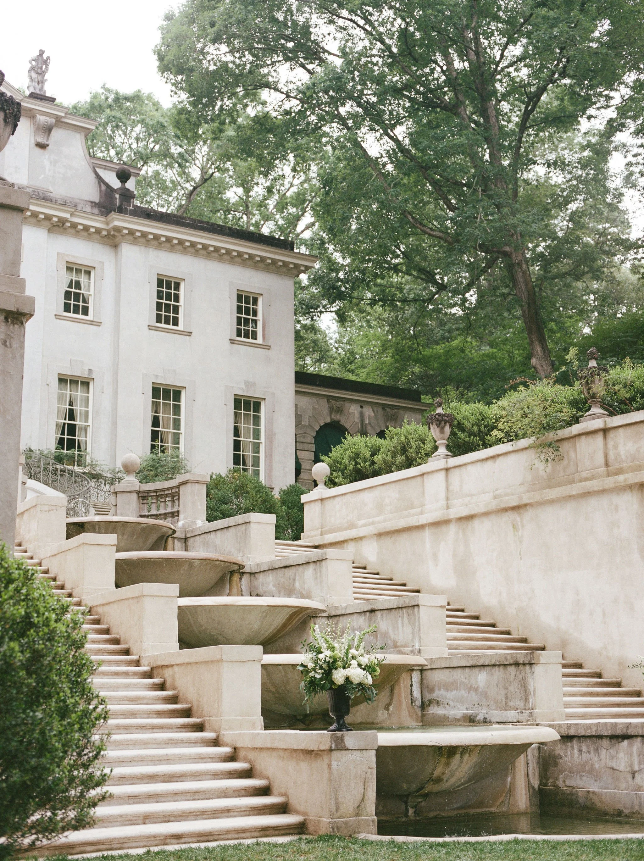 Outdoor wedding ceremony at Swan House Atlanta History Center with elegant garden and estate backdrop.