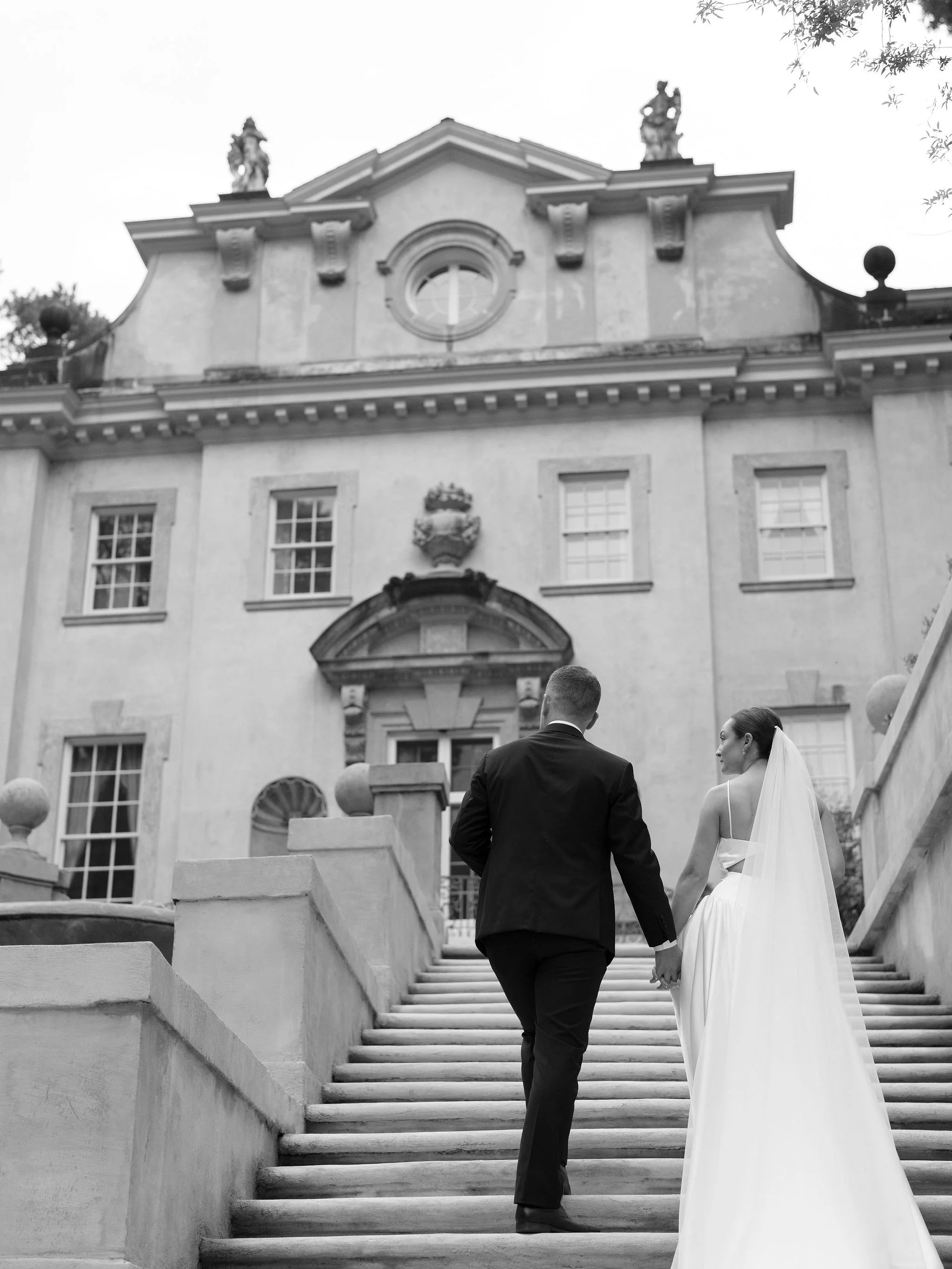 Bride and groom walking through Swan House gardens in Atlanta Georgia during romantic wedding portraits