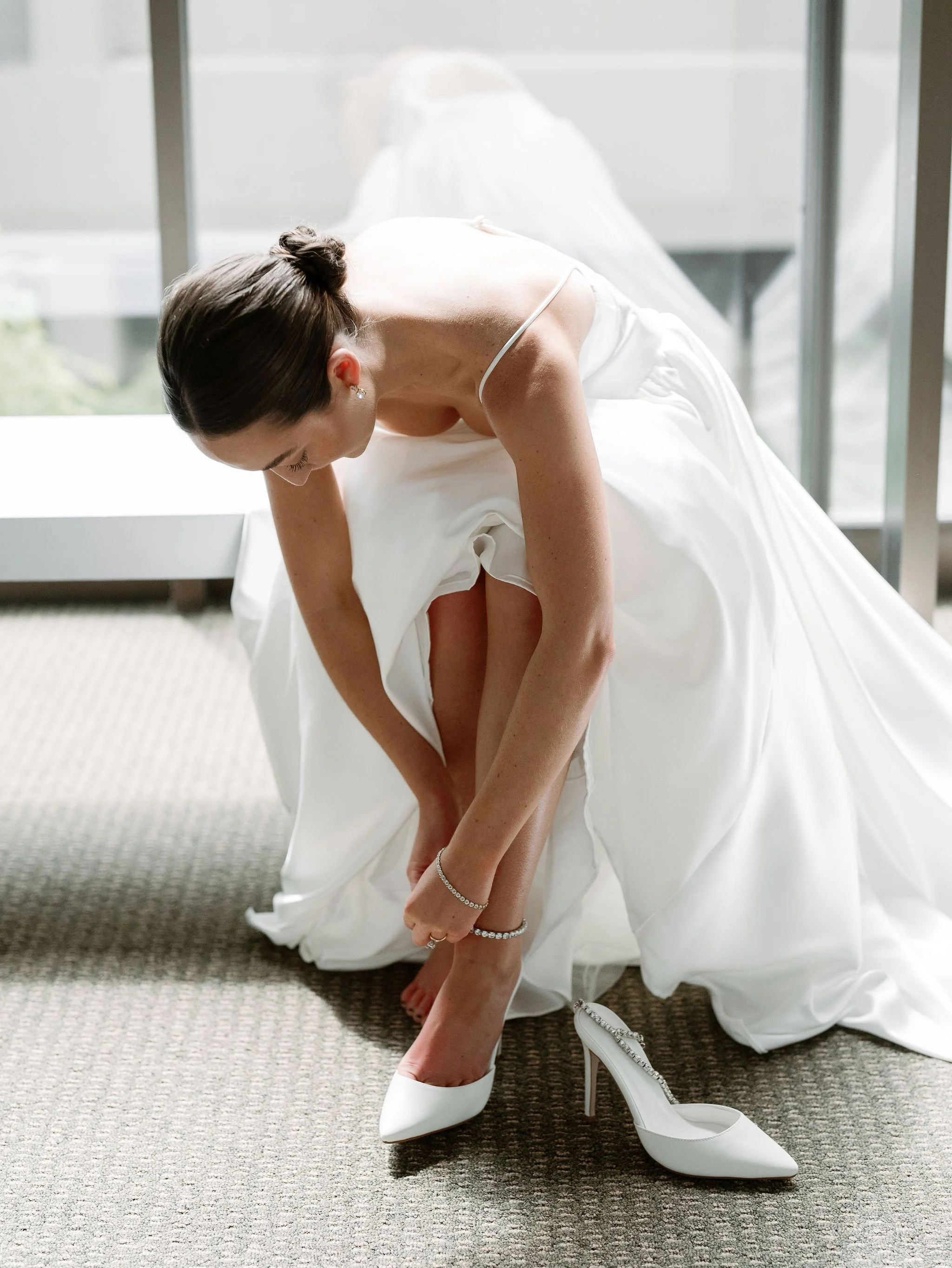 Bride getting ready at Swan House wedding in Atlanta Georgia with natural window light and editorial bridal portrait.
