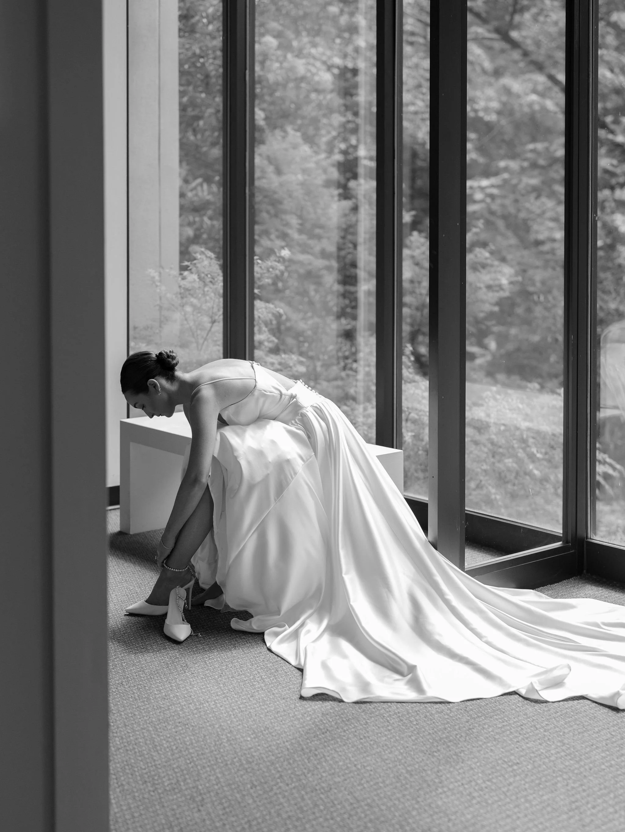 Bride getting ready at Swan House wedding in Atlanta Georgia with natural window light and editorial bridal portrait.
