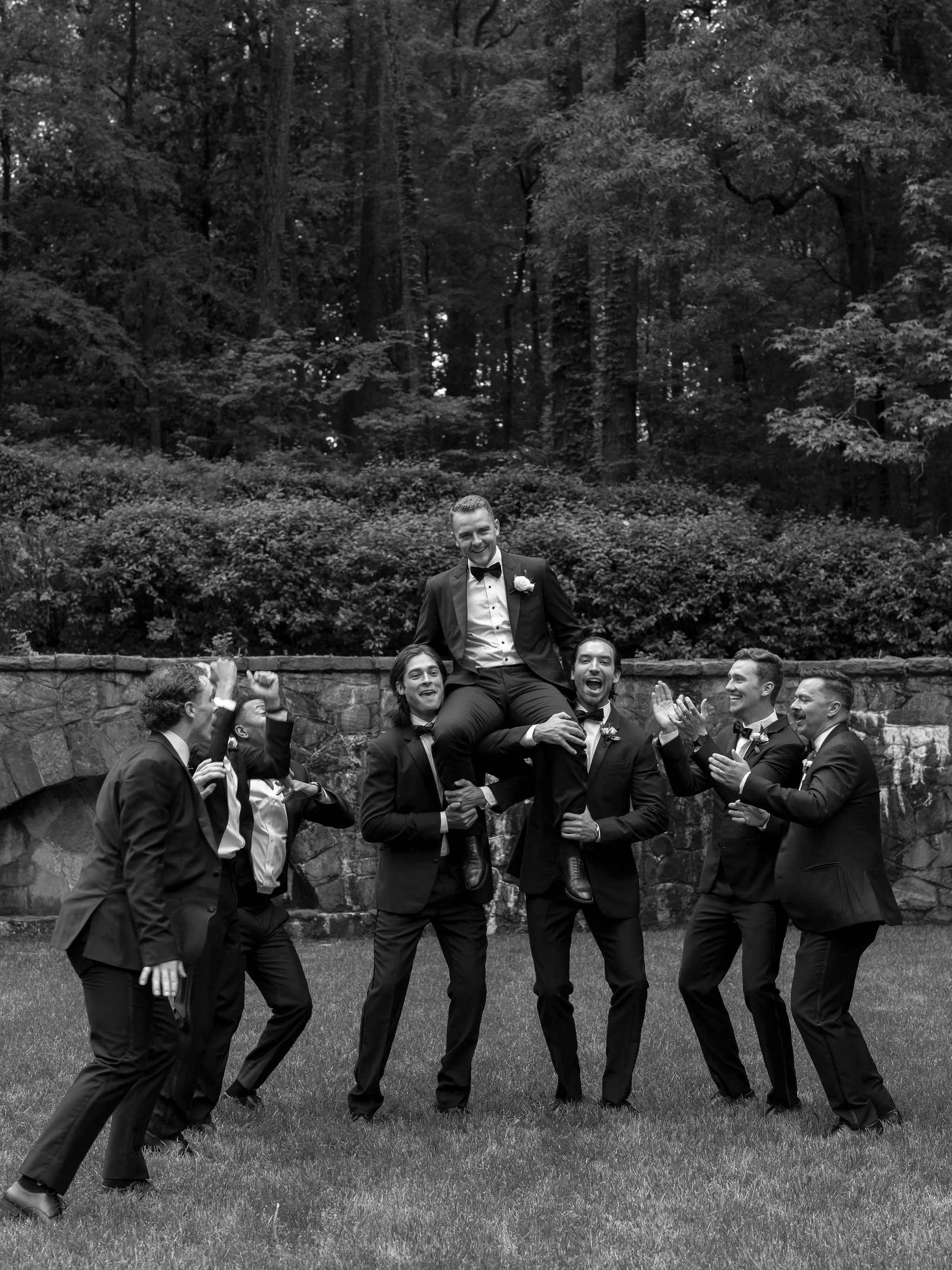 groomsmen walking through Swan House gardens in Atlanta Georgia during romantic wedding portraits