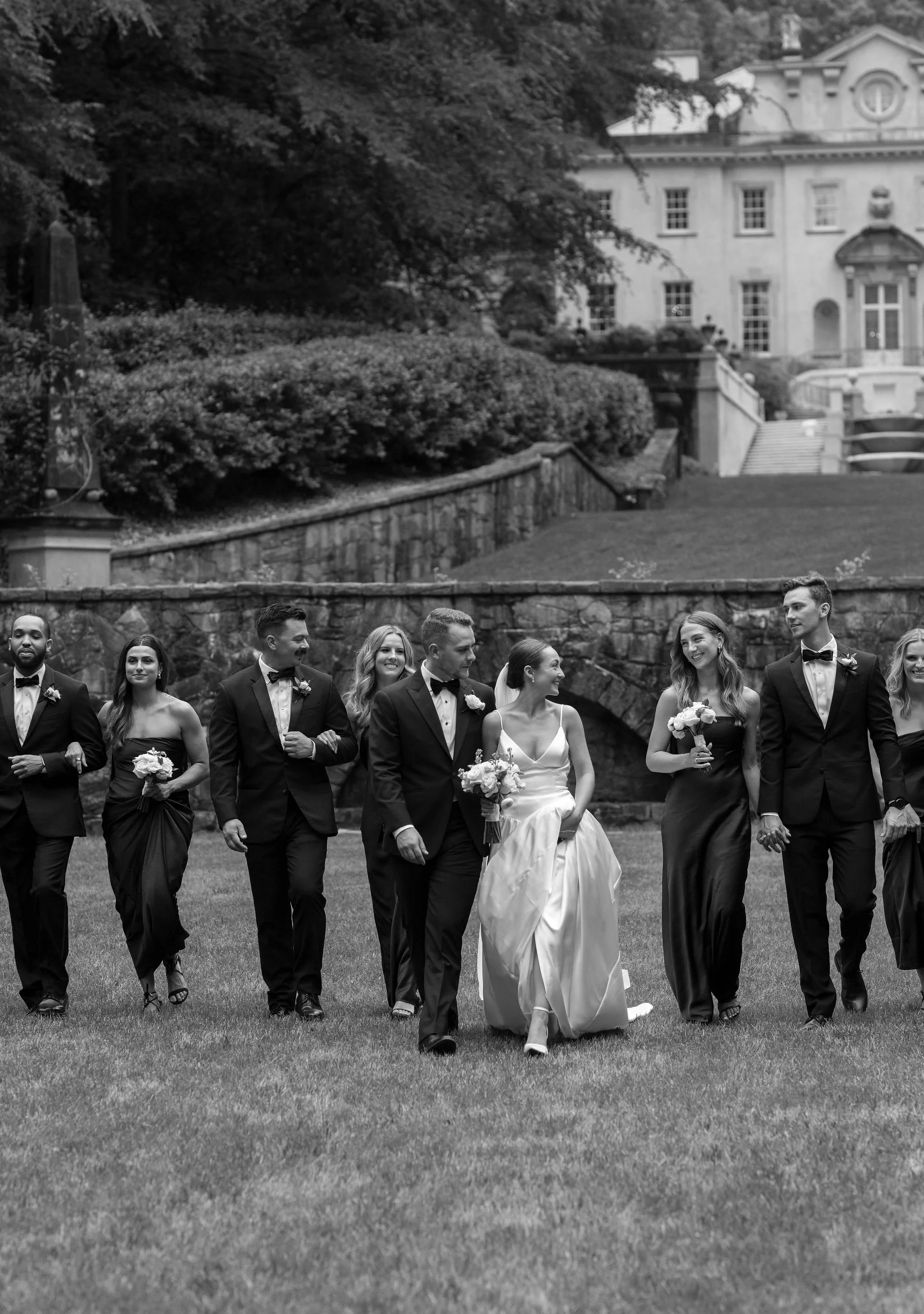 Bride and groom walking through Swan House gardens in Atlanta Georgia during romantic wedding portraits