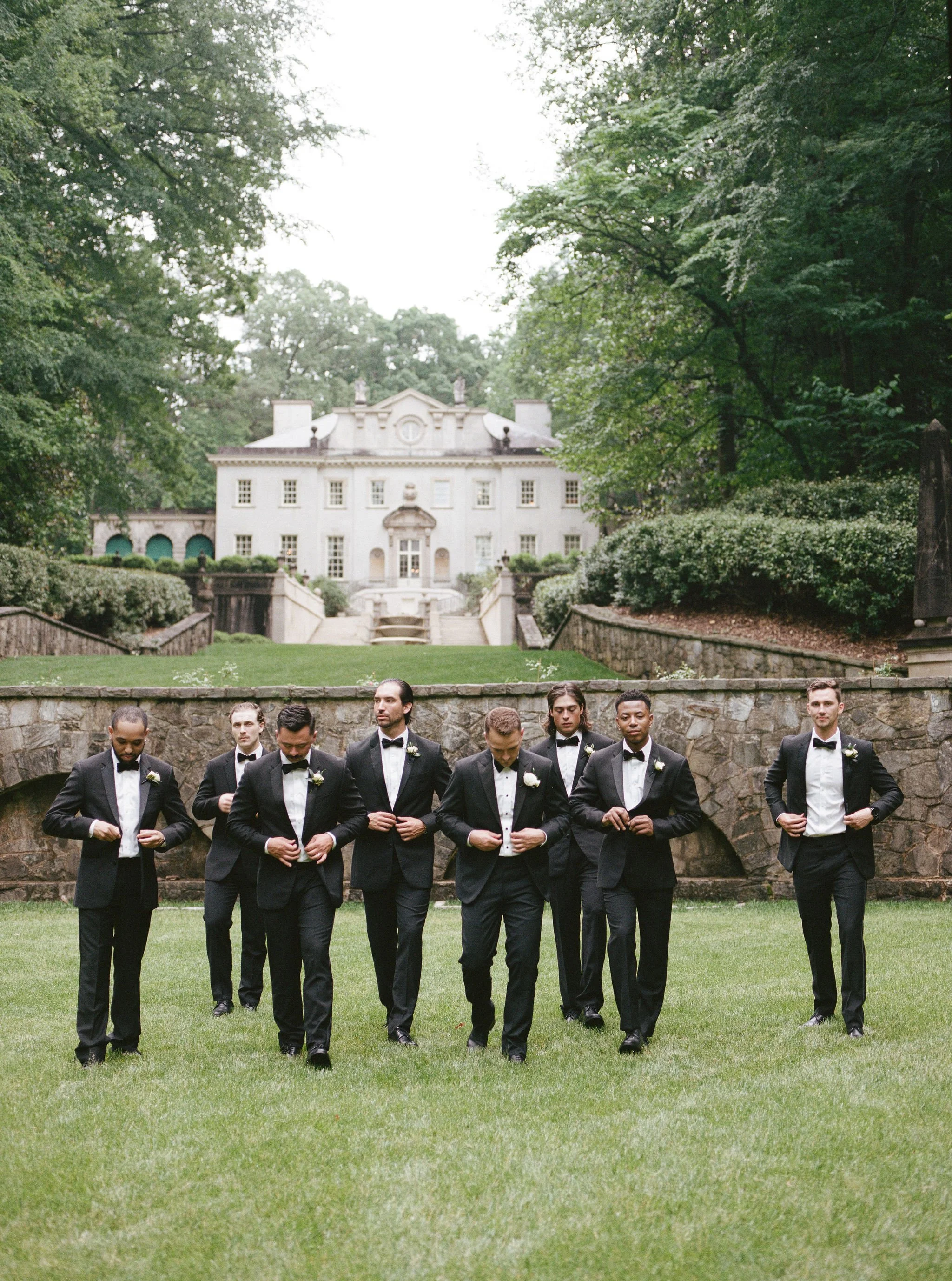 Bride and groom walking through Swan House gardens in Atlanta Georgia during romantic wedding portraits
