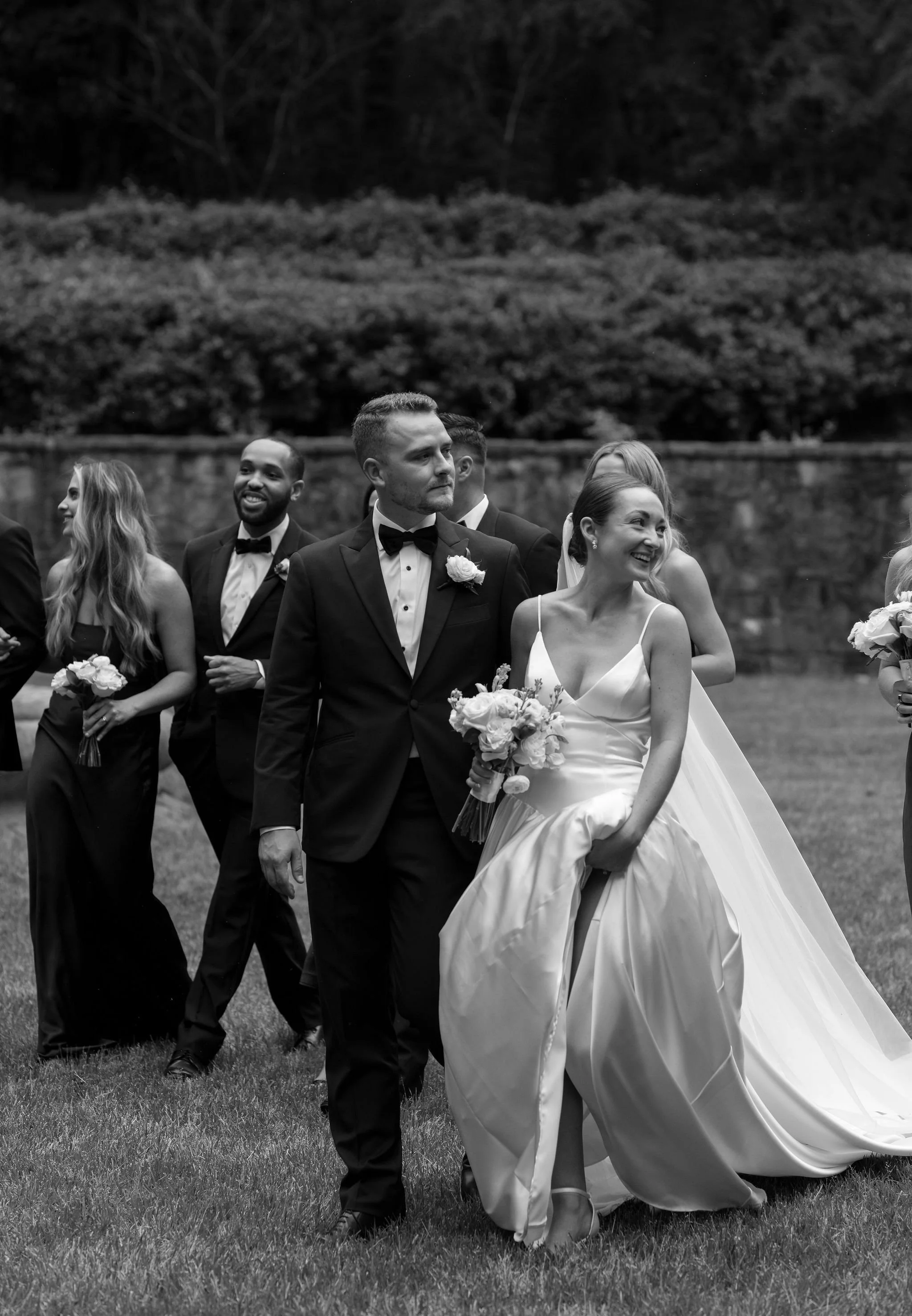 Bride and groom walking through Swan House gardens in Atlanta Georgia during romantic wedding portraits