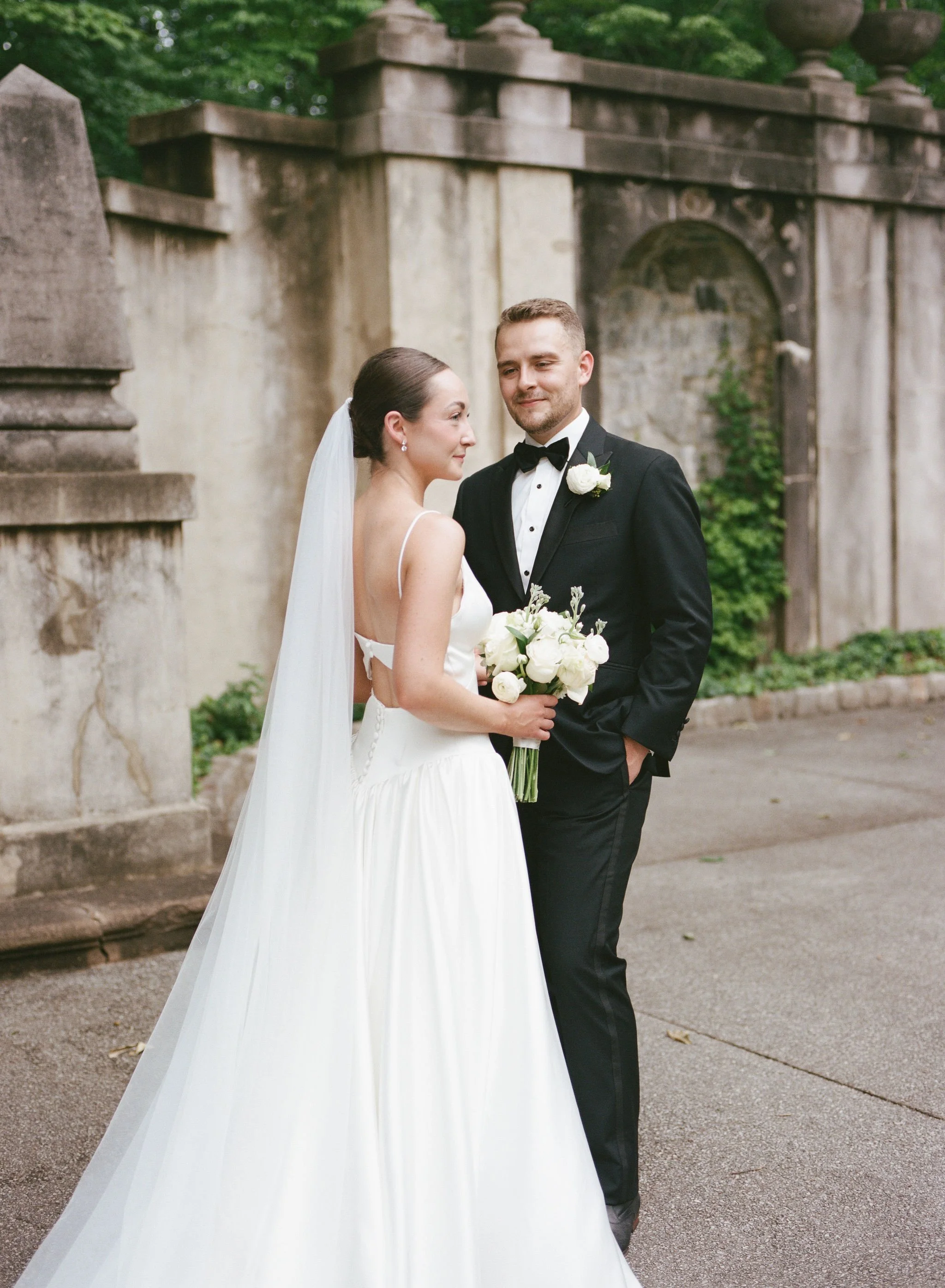 Bride and groom walking through Swan House gardens in Atlanta Georgia during romantic wedding portraits