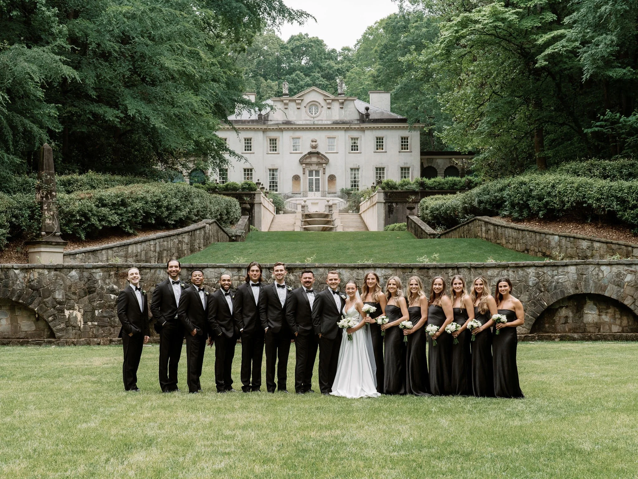 Bride and groom walking through Swan House gardens in Atlanta Georgia during romantic wedding portraits