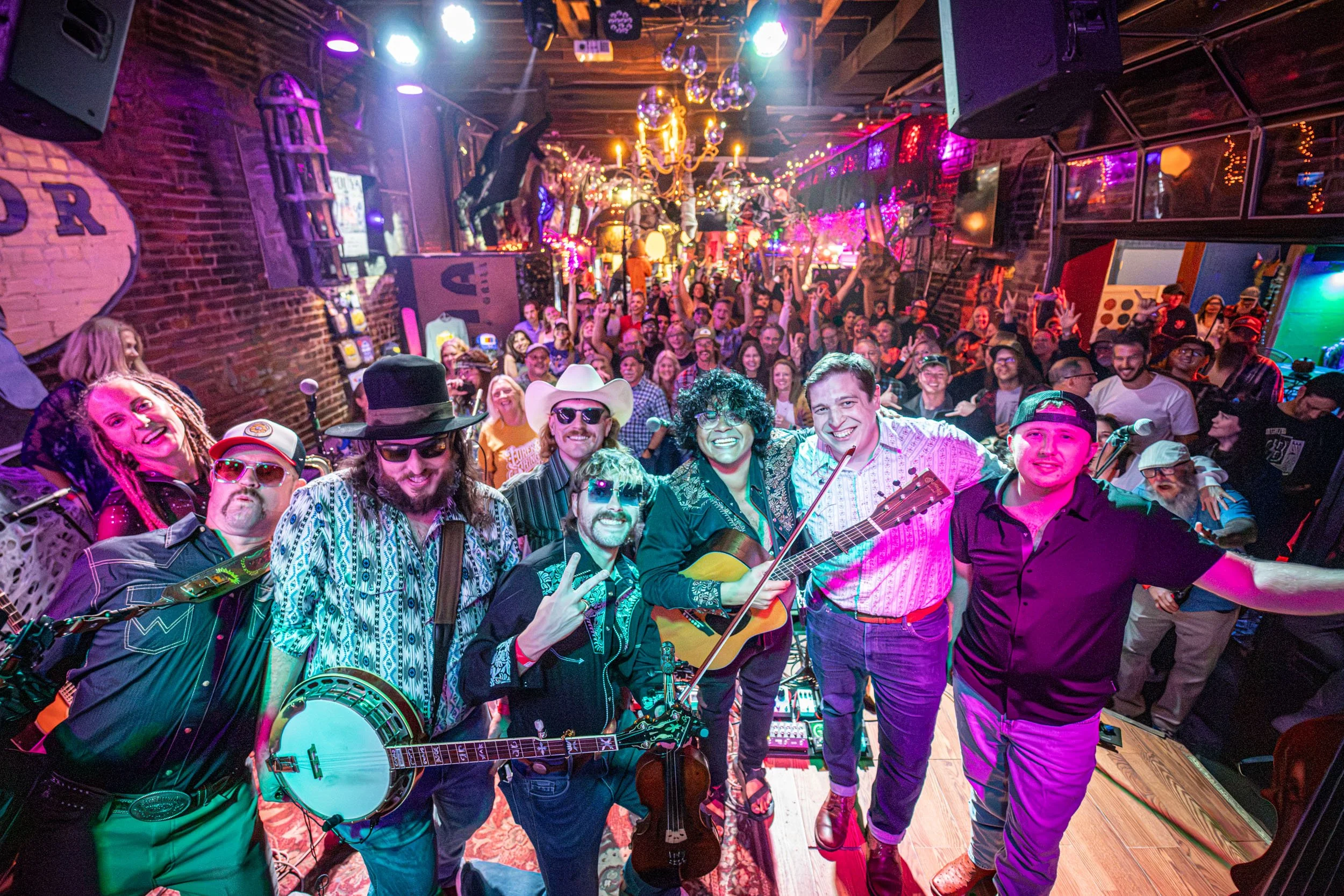Nash Grass Unit with instruments and a cheering crowd at Lucia in Lawrence, Kansas. Photo: JD Benning.