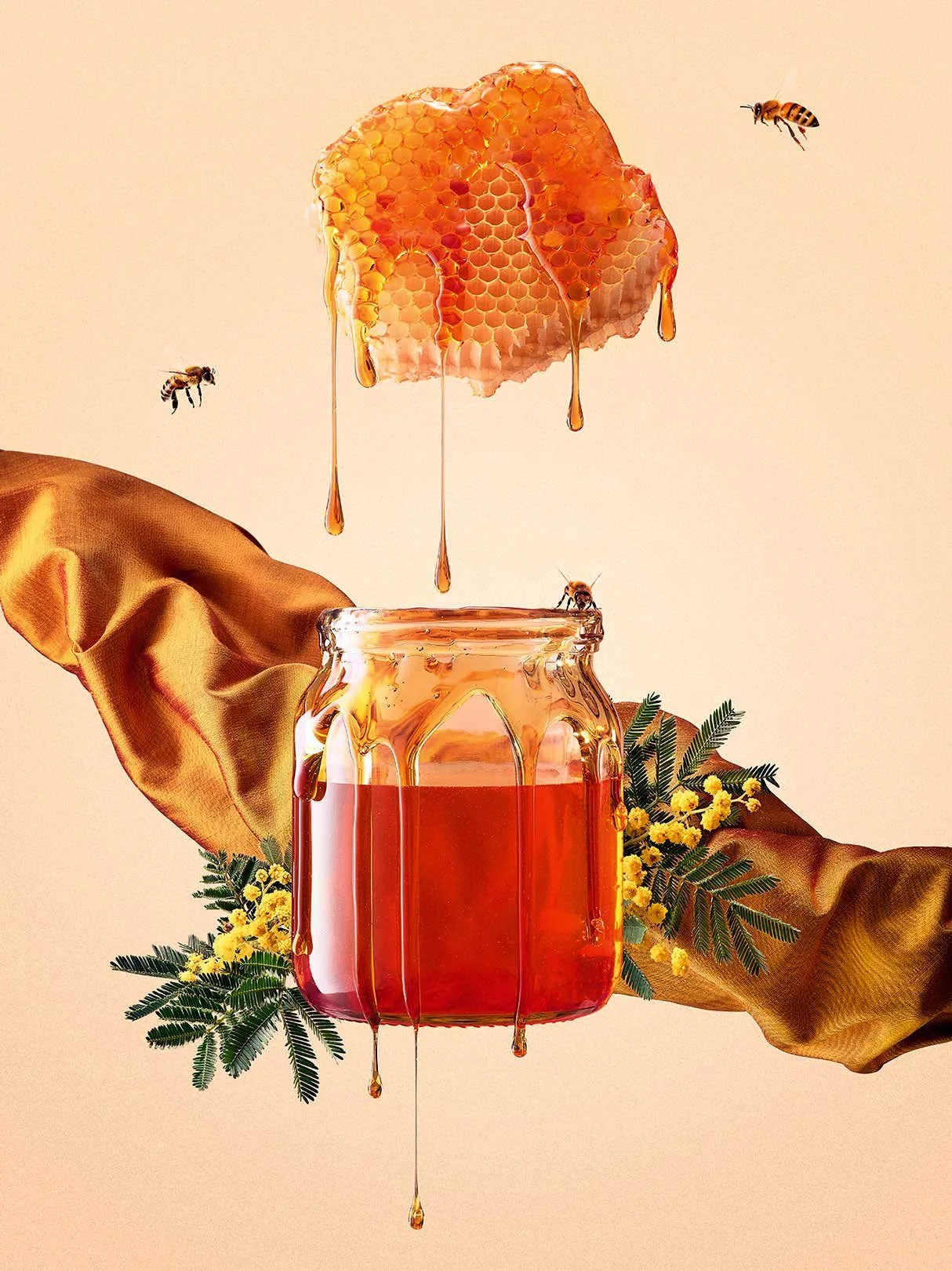 Honeycomb dripping honey into jar with bees flying around and surrounded by yellow flowers and green fern leaves.