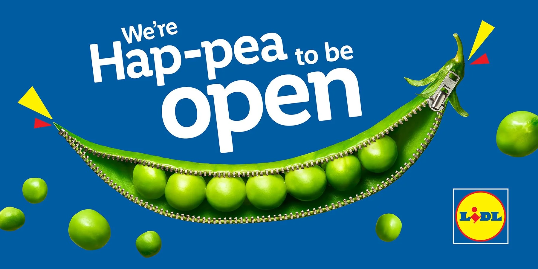 Lidl advertisement featuring a zipper partially opening a green pea pod, with green peas and the text 'We're Hap-pea to be open' on a blue background.