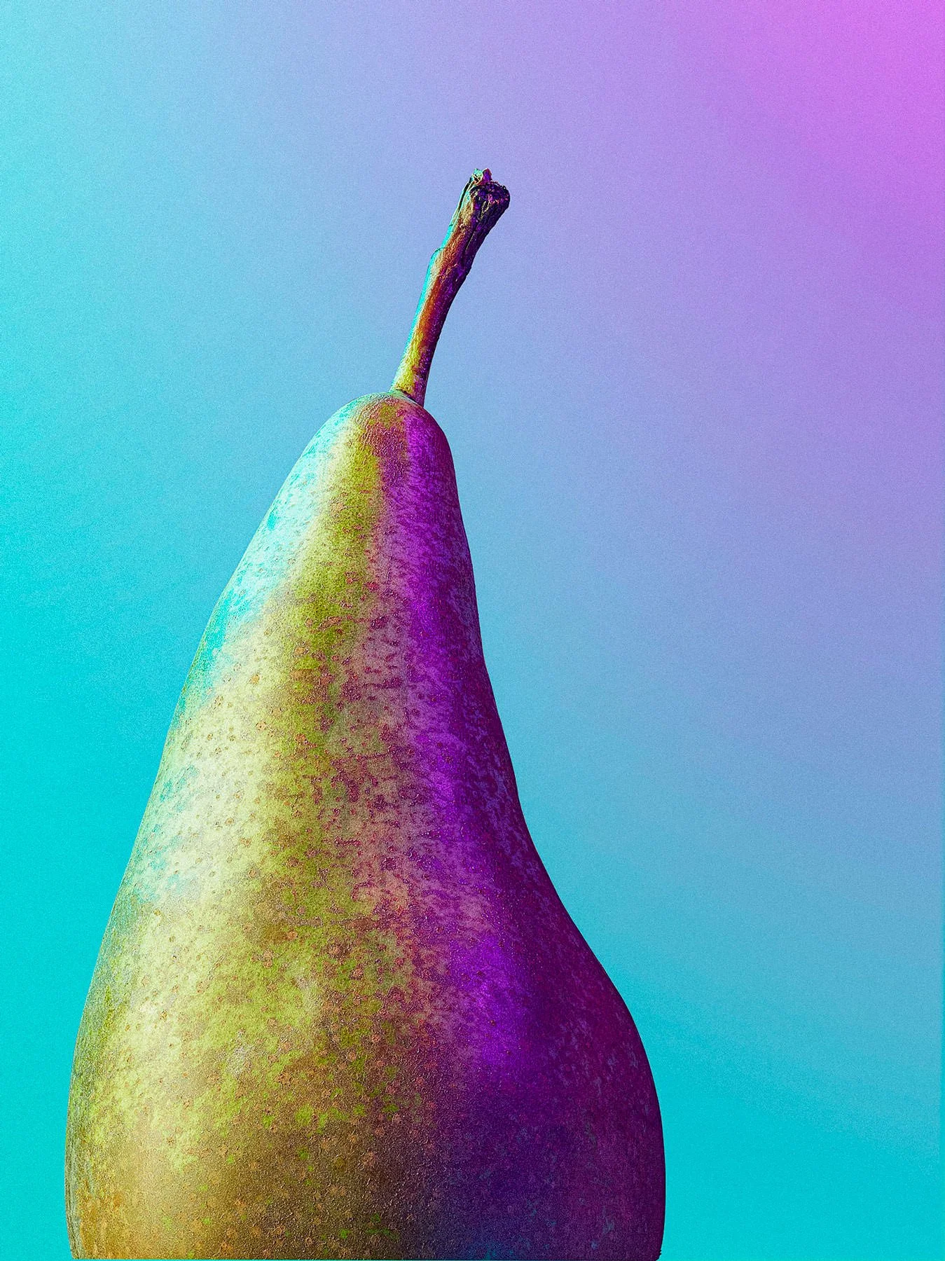 A pear with a gradient filter in purple, yellow, and blue tones.