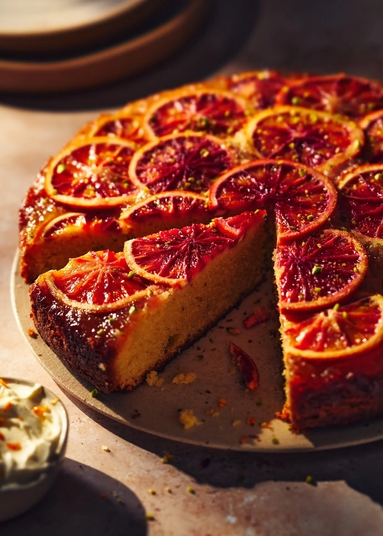 Ryan Ball food photographer — Blood orange upside-down cake with slices of blood orange on top, served on a white plate. Life-style food