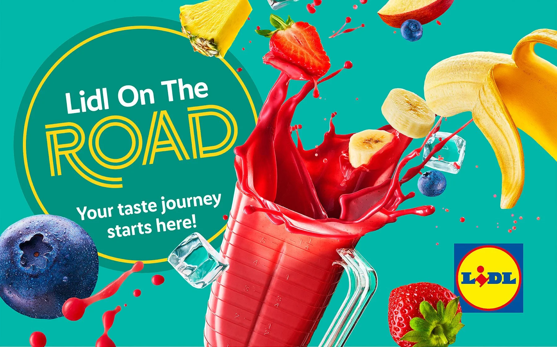 Colorful advertisement for Lidl, featuring a measuring jug with splashing red juice and floating fruits including strawberries, bananas, blueberries, a pineapple, and a lemon. The Lidl logo is present in the bottom right corner.