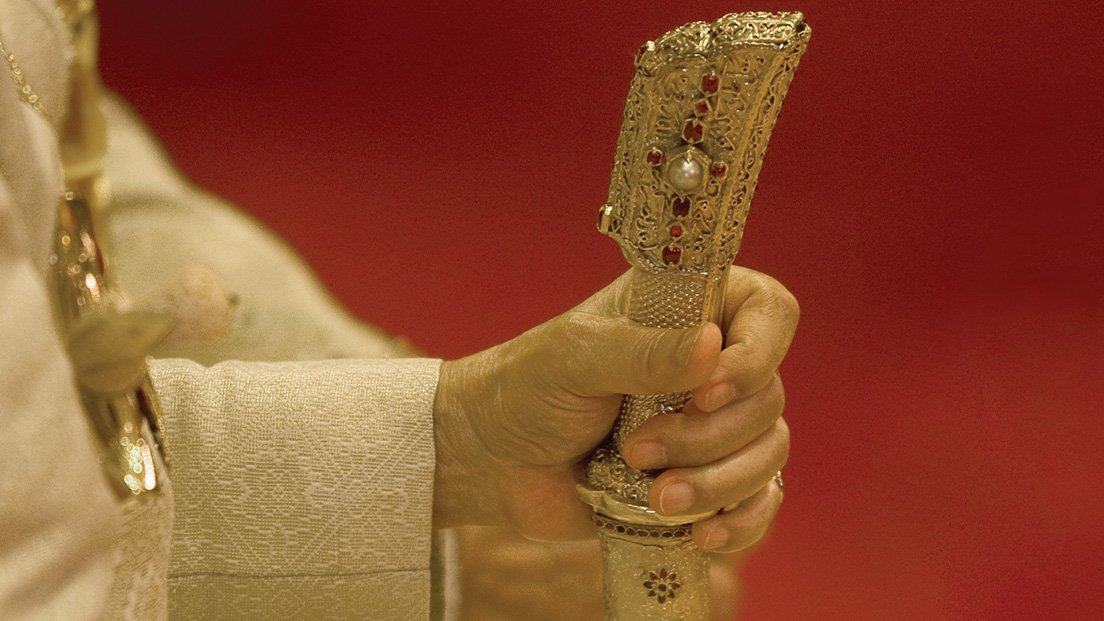 Close-up hand of Sultan Azlan Shah holding his ceremonial sword, focusing on grip and detail
