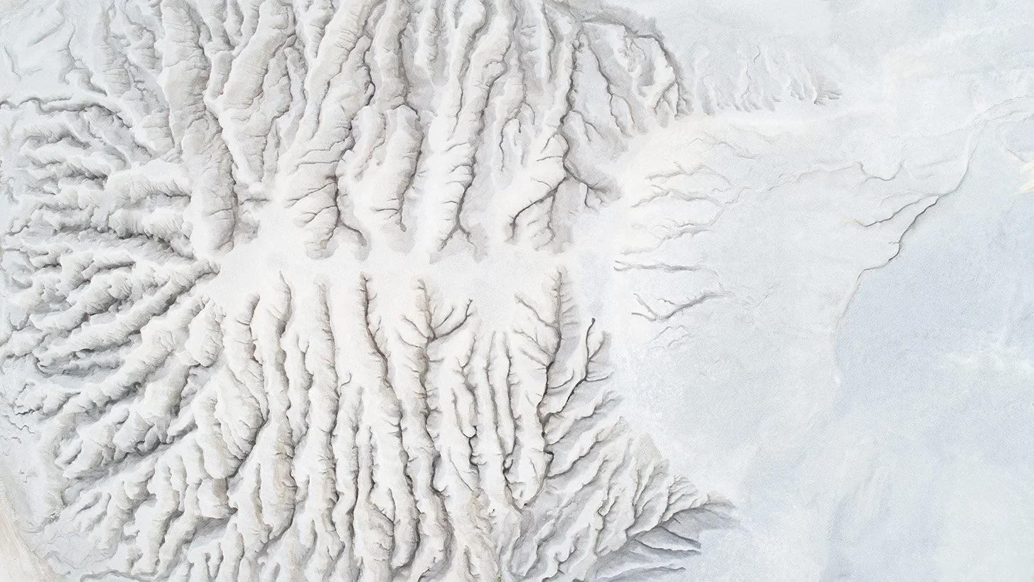 Aerial view of a sand mine showing brain-like formations and intricate ridges shaped by excavation and erosion.