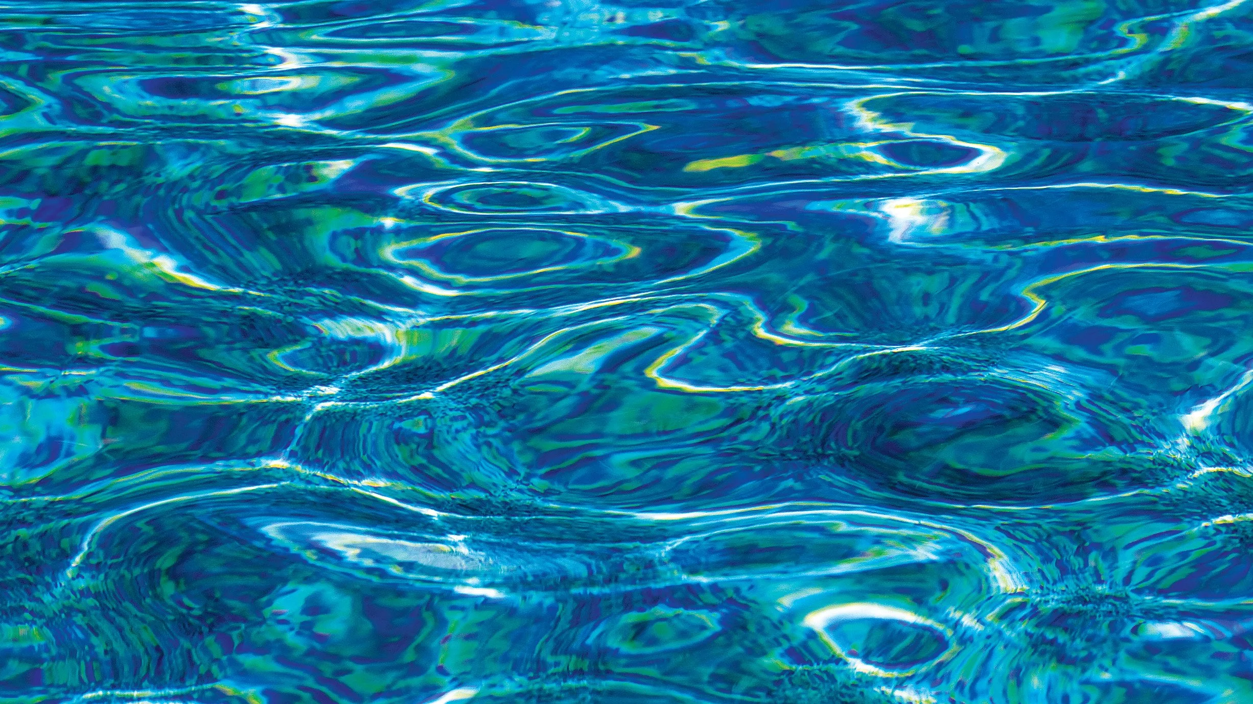 Abstract patterns formed by moving water, captured as flowing lines and tonal contrasts.