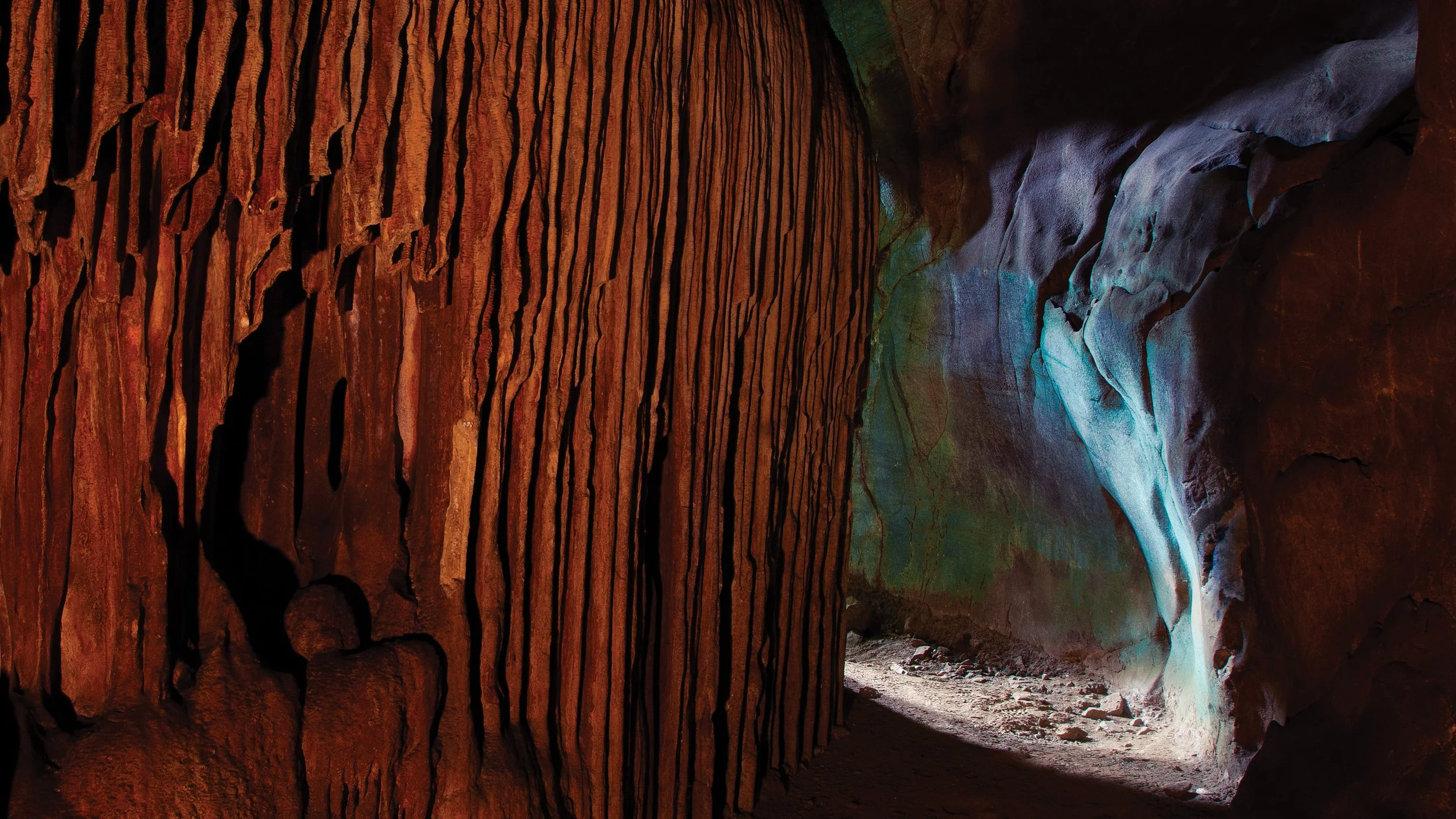 Textured cave wall revealing mineral patterns shaped by water, pressure, and geological time.