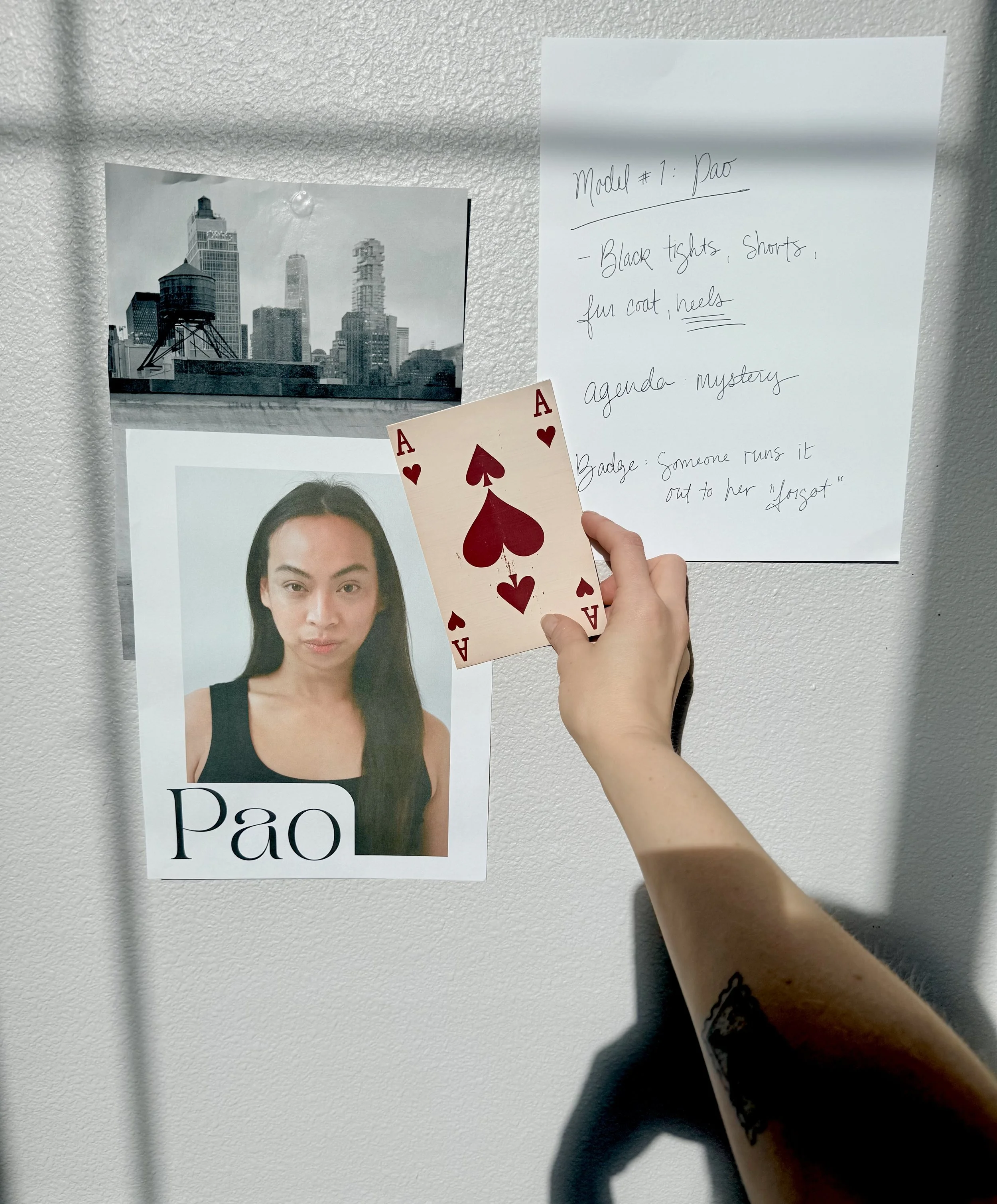 A fashion model is being considered for their role in a fashion show called Muse Behavior Runway in Portland, Oregon. The model has striking features and dark hair. There is a scene of New York City in the background and list of ideas next to it.
