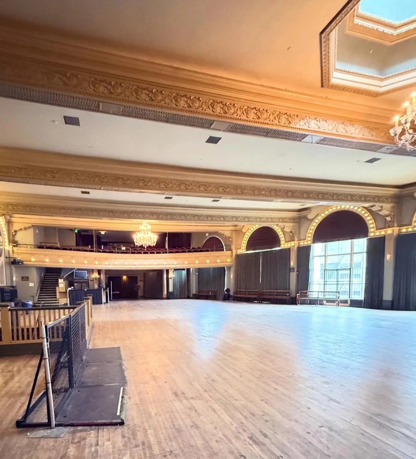 A view from the back of Crystal Ballroom as we prepare for Muse Behavior Runway in Portland, OR. It's a decorative ballroom of mostly gold and has floor to ceiling windows.