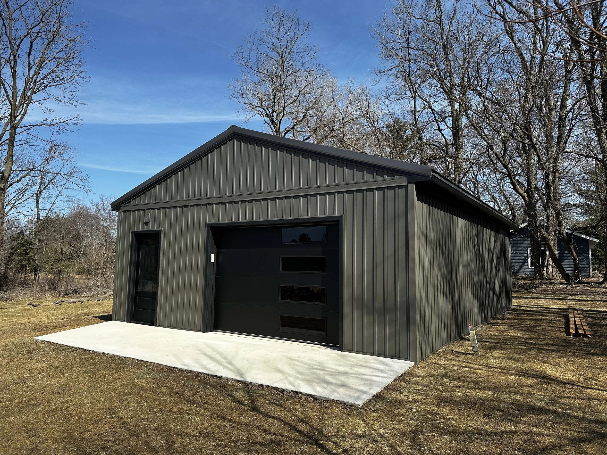 Three-quarter profile view of the finished pole barn style garage building.