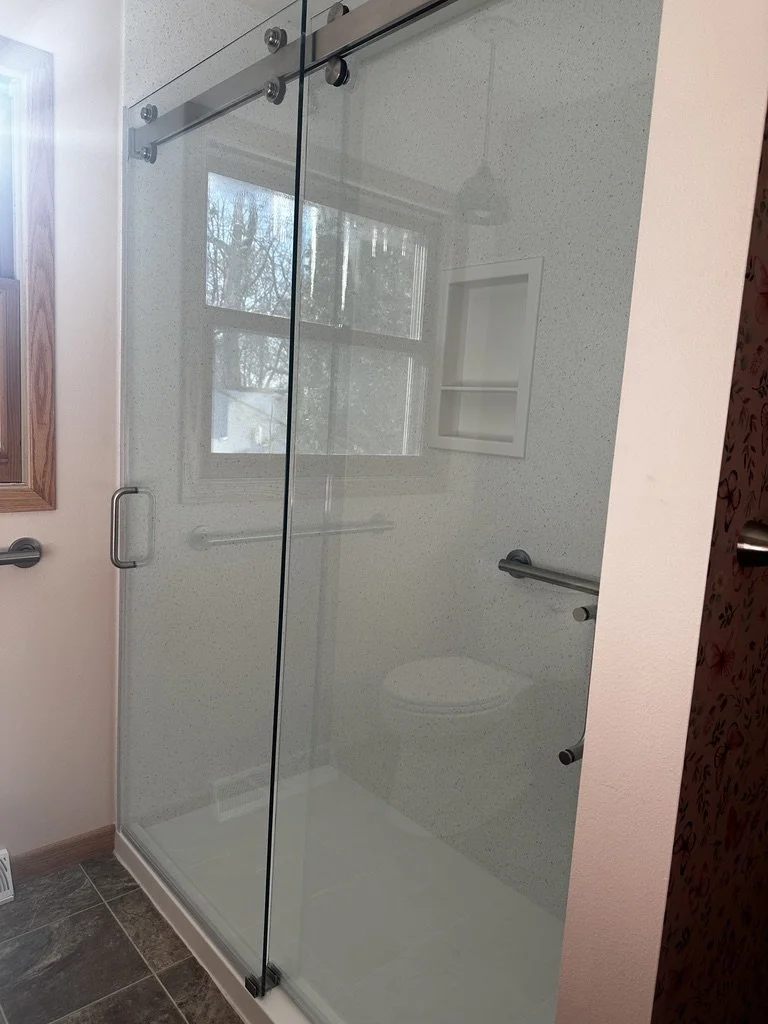 Custom solid surface Corian Ice Queen walk-in shower surround.
