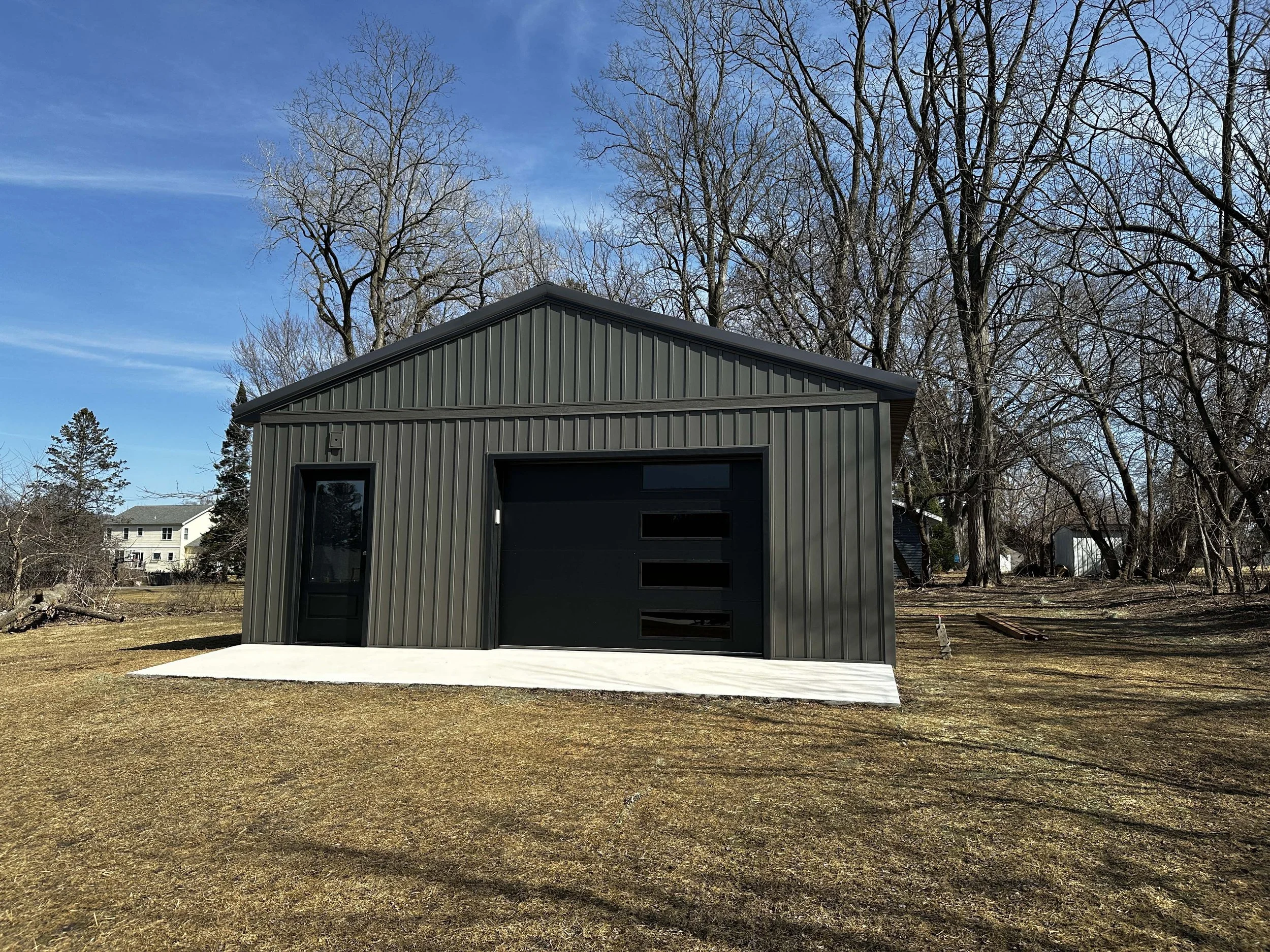 Custom garage built by Root Down Remodeling showcasing precise vertical siding panels.
