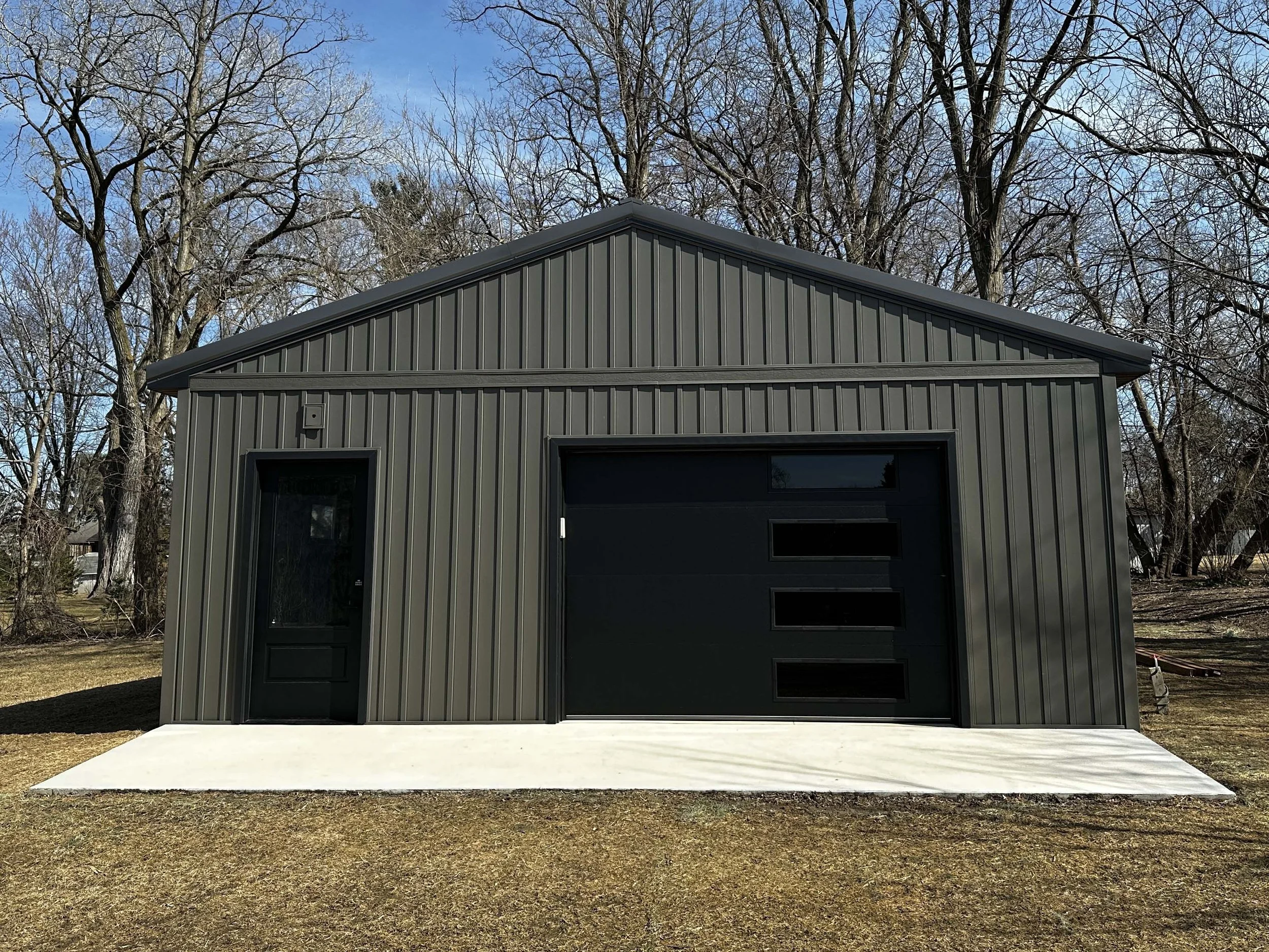 Front elevation view of the completed detached workshop by Root Down Remodeling.