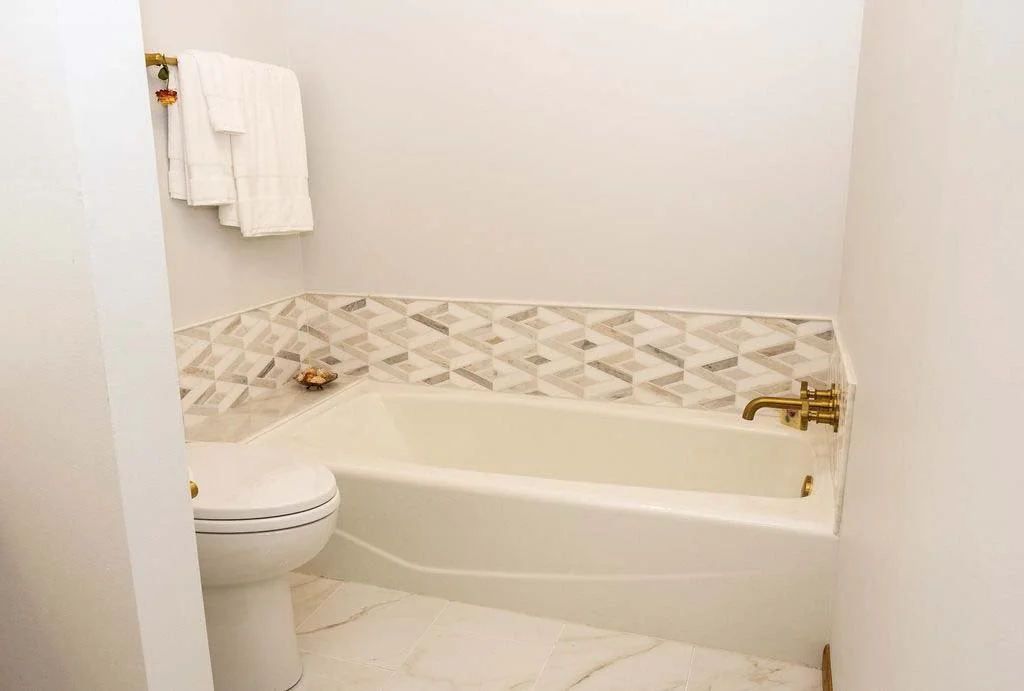 root-down-remodeling-bathroom-remodel-tub-and-toilet-with-tile-backsplash.jpg
