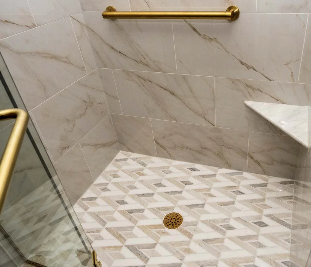 root-down-remodeling-bathroom-remodel-tile-shower-floor-with-gold-fixtures.jpg