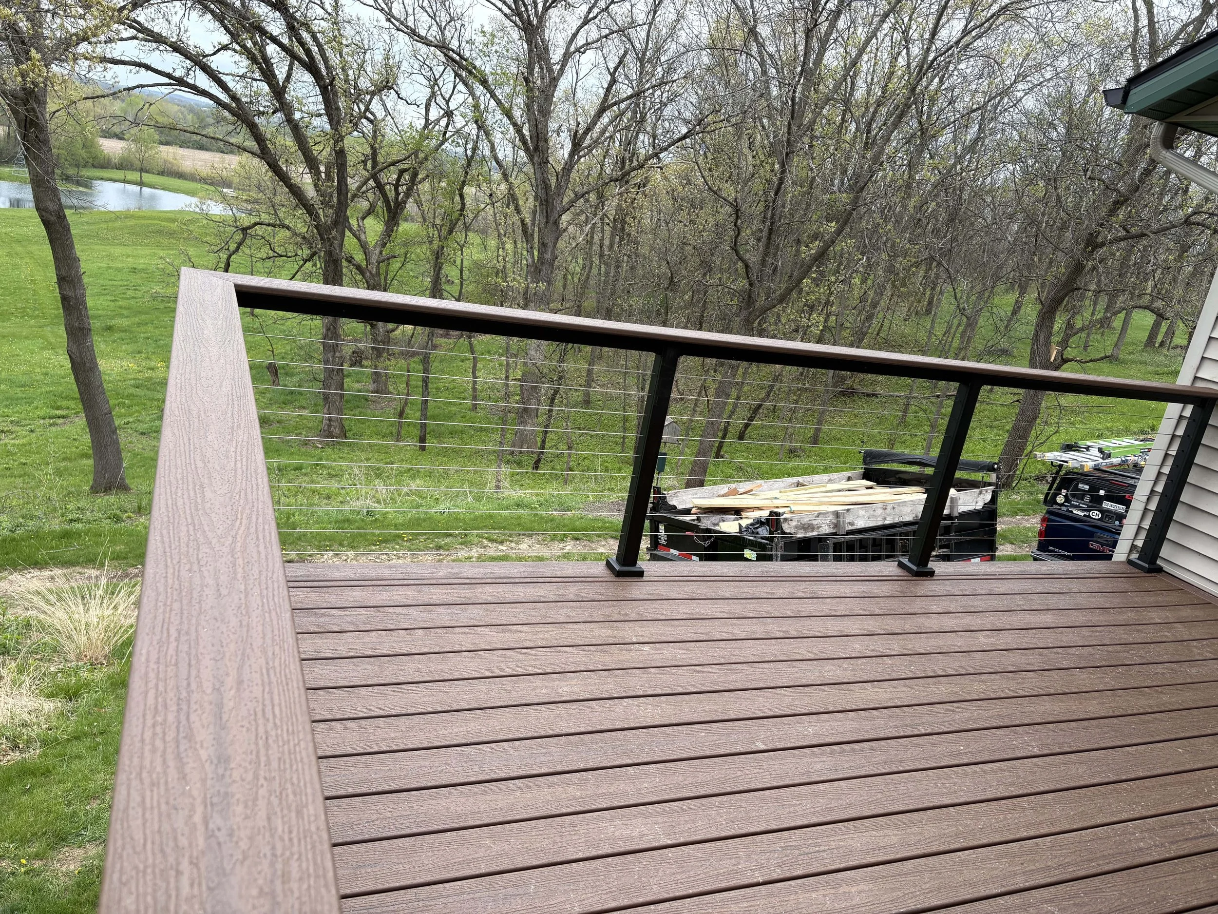 Detailed view of durable composite deck boards and a weather-resistant black aluminum railing installation.