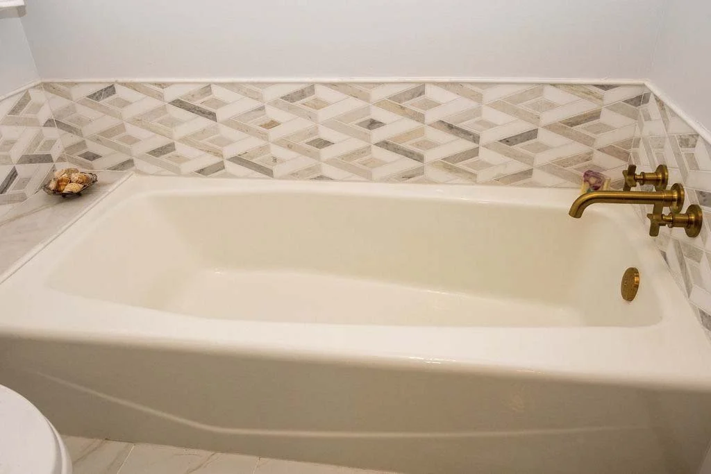 root-down-remodeling-bathroom-remodel-tub-with-gold-fixtures-tile-backsplash.jpg