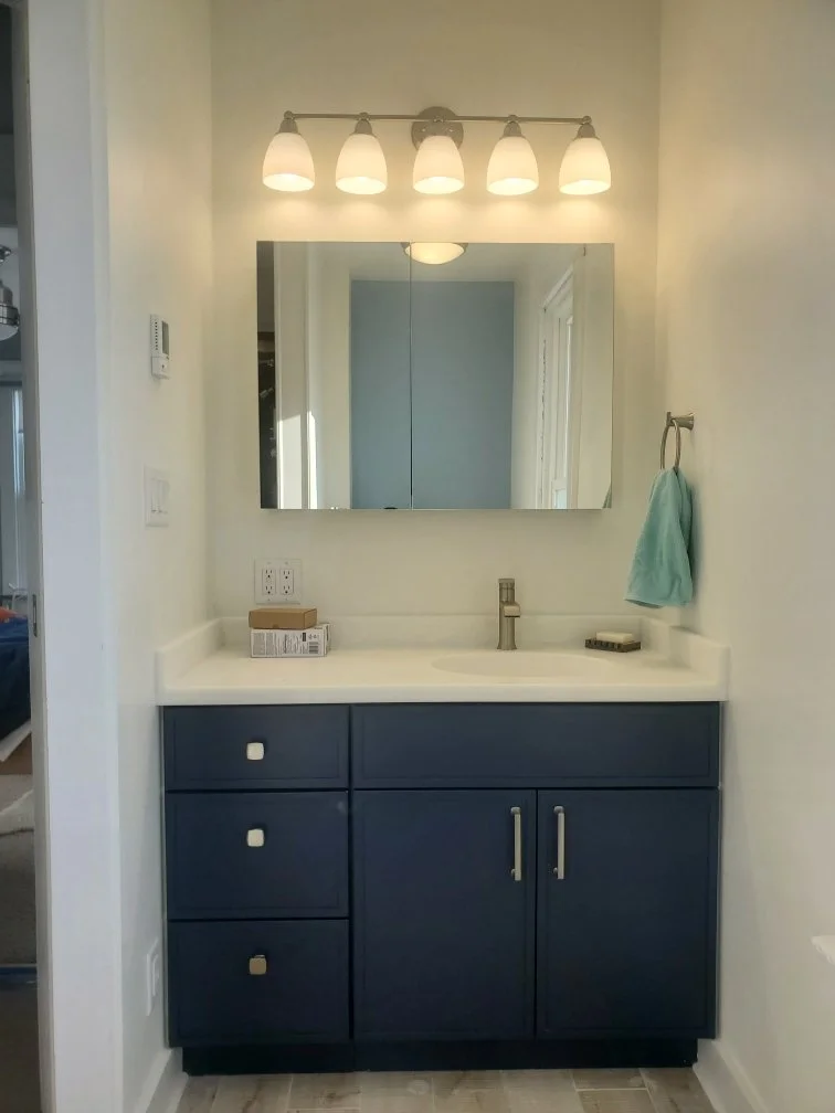 root-down-remodeling-bathroom-vabity-custom-blue-mirror-lighting.jpeg