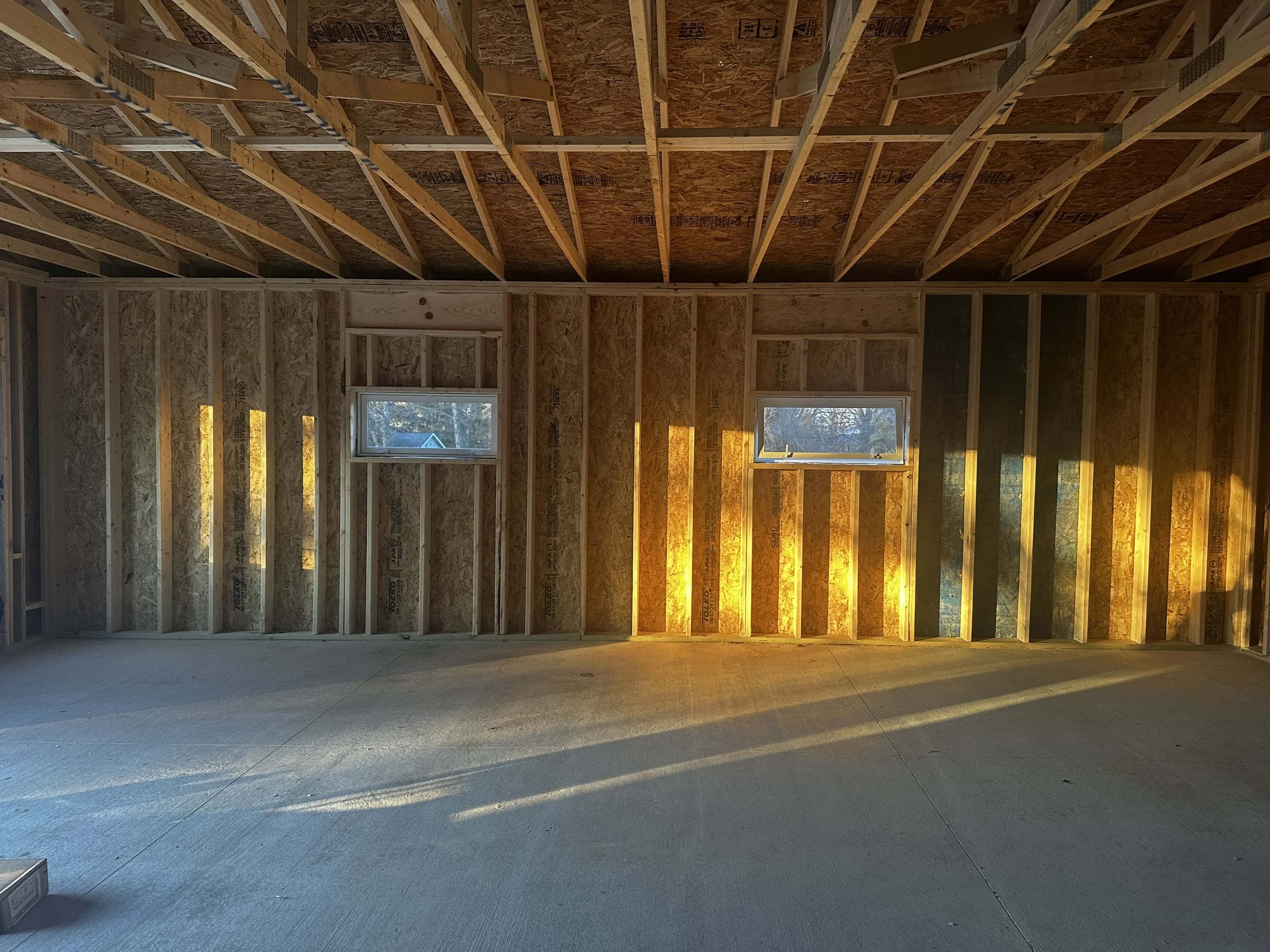 Interior view of the detached garage framing highlighting exposed wood wall studs.