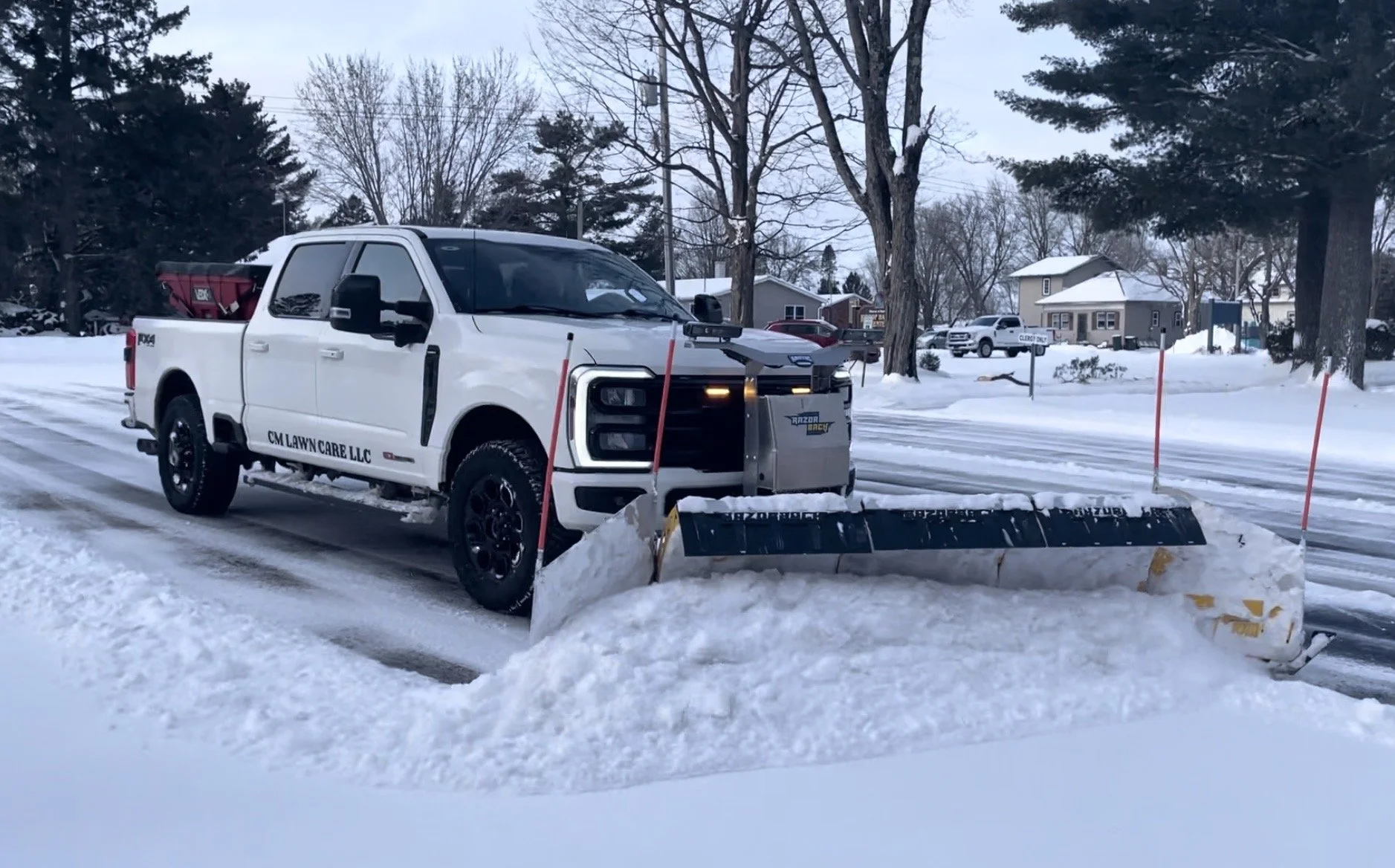 ford f250 with arctic razorback plow. CM Lawn Care LLC plowing Haugen holy trinity church