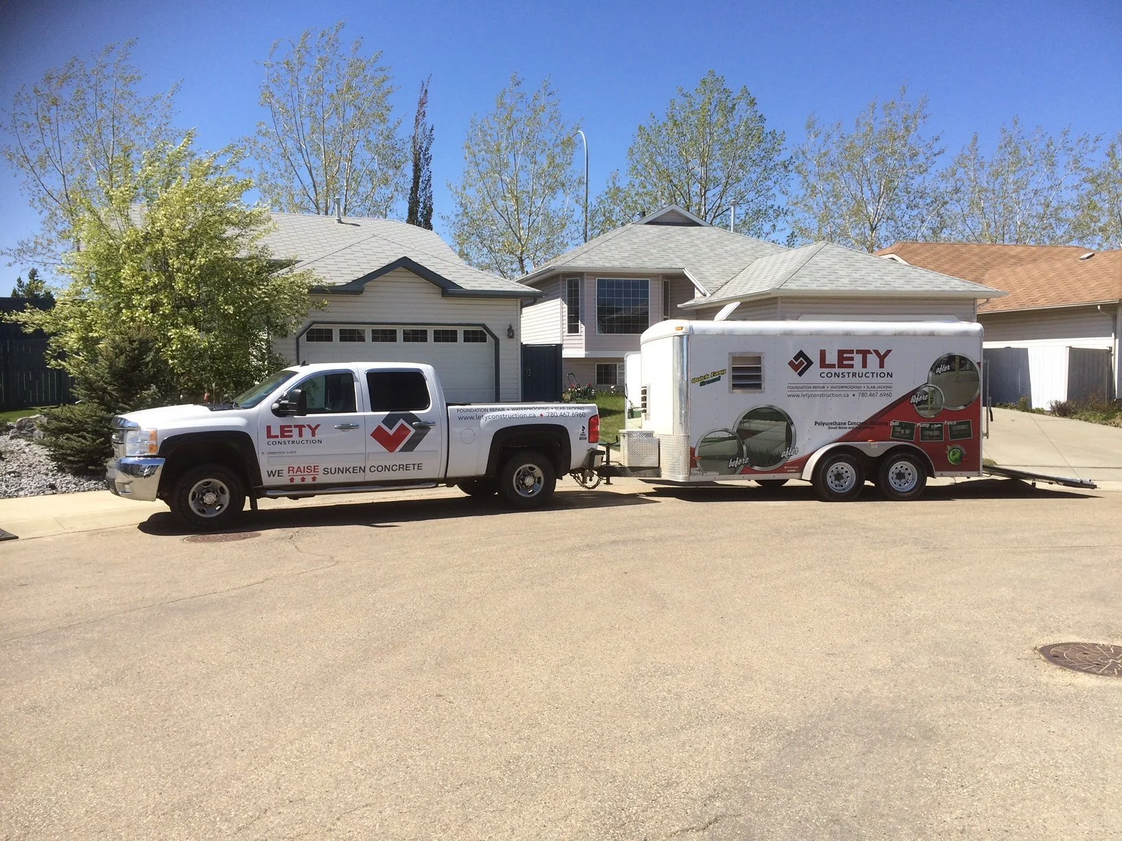 Lety truck and trailer on residential street.