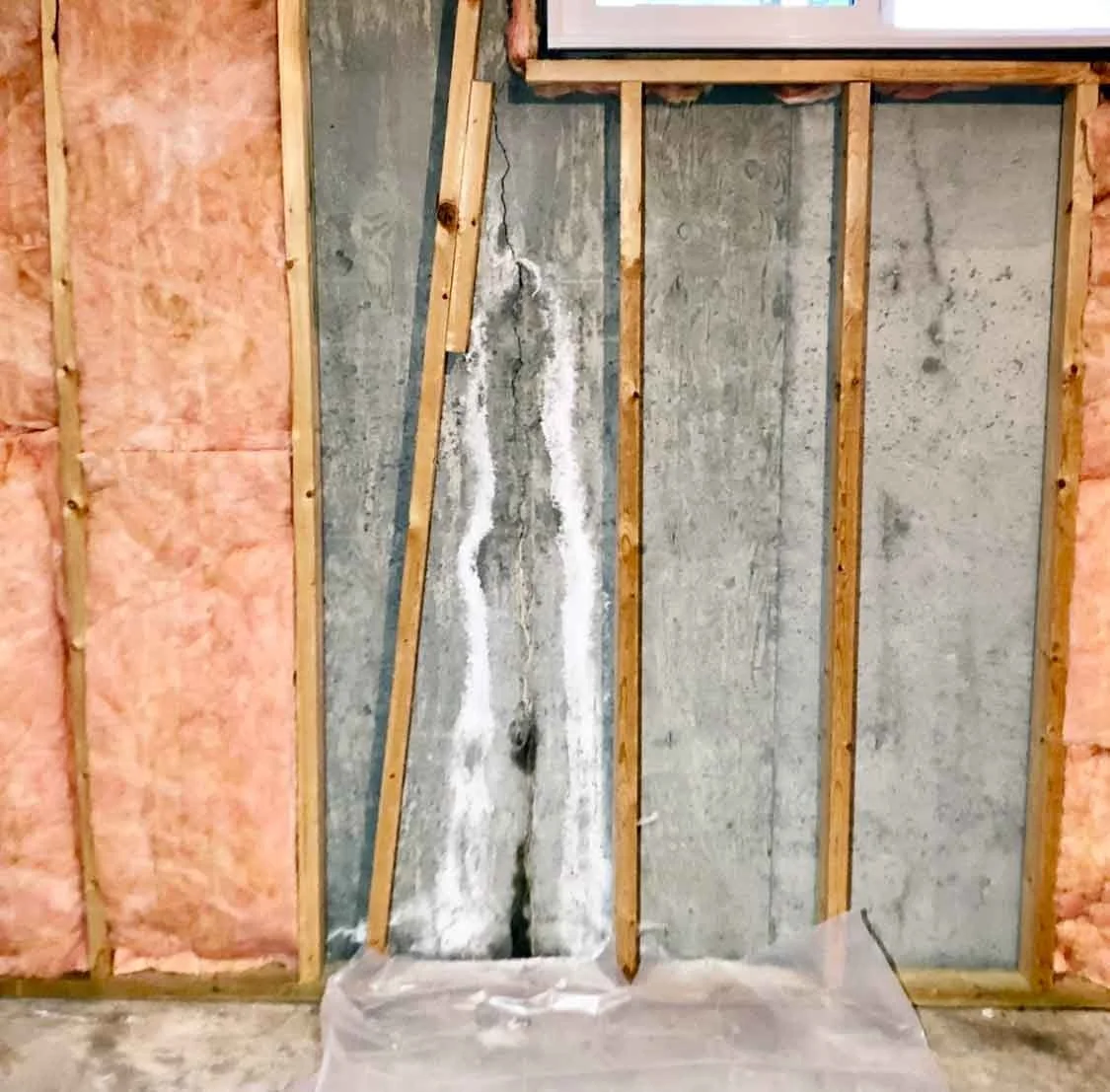 Vertical foundation cracks in basement wall with repair process by LETY Construction.