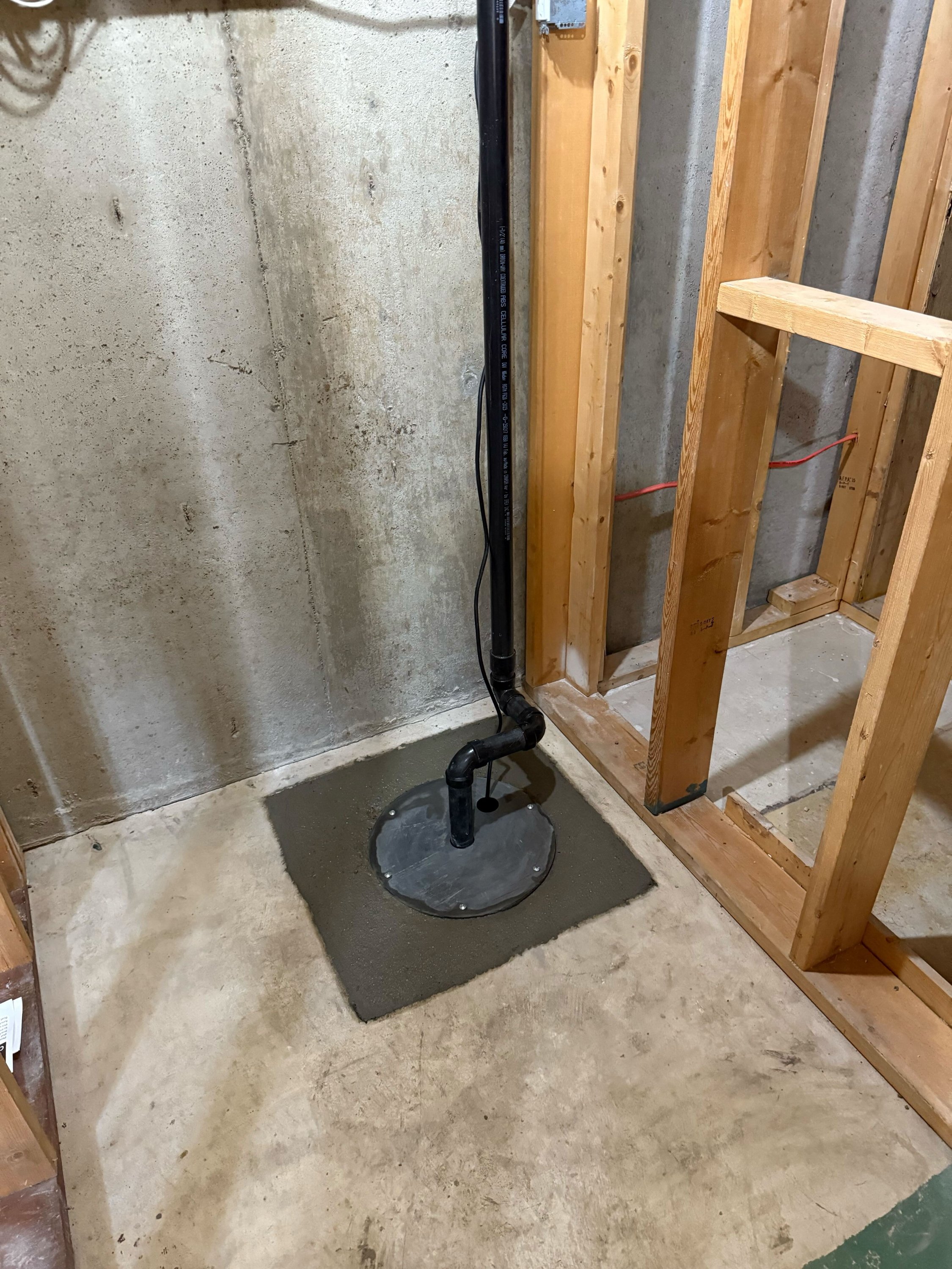 Sump basin and pump, installed as part of a new weeping tile system, to discharge collected water.