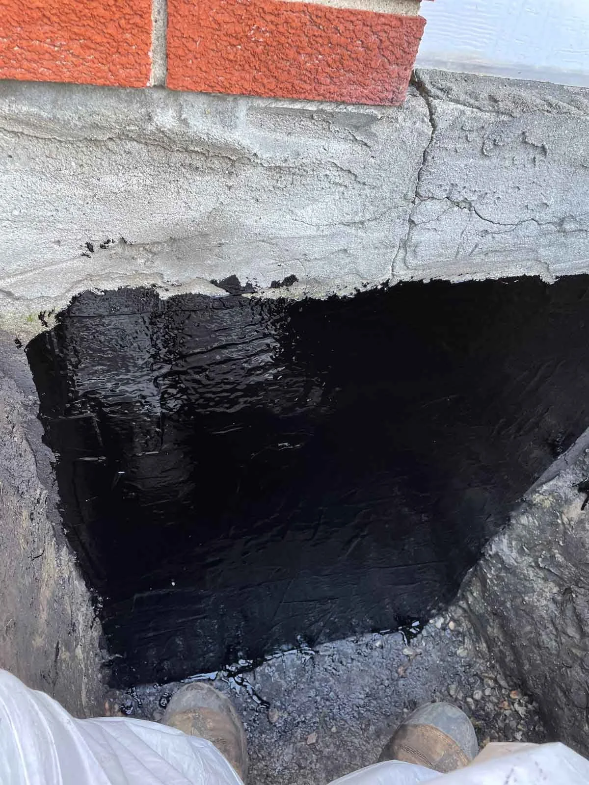 Preparing foundation crack for waterproofing with membrane on site.