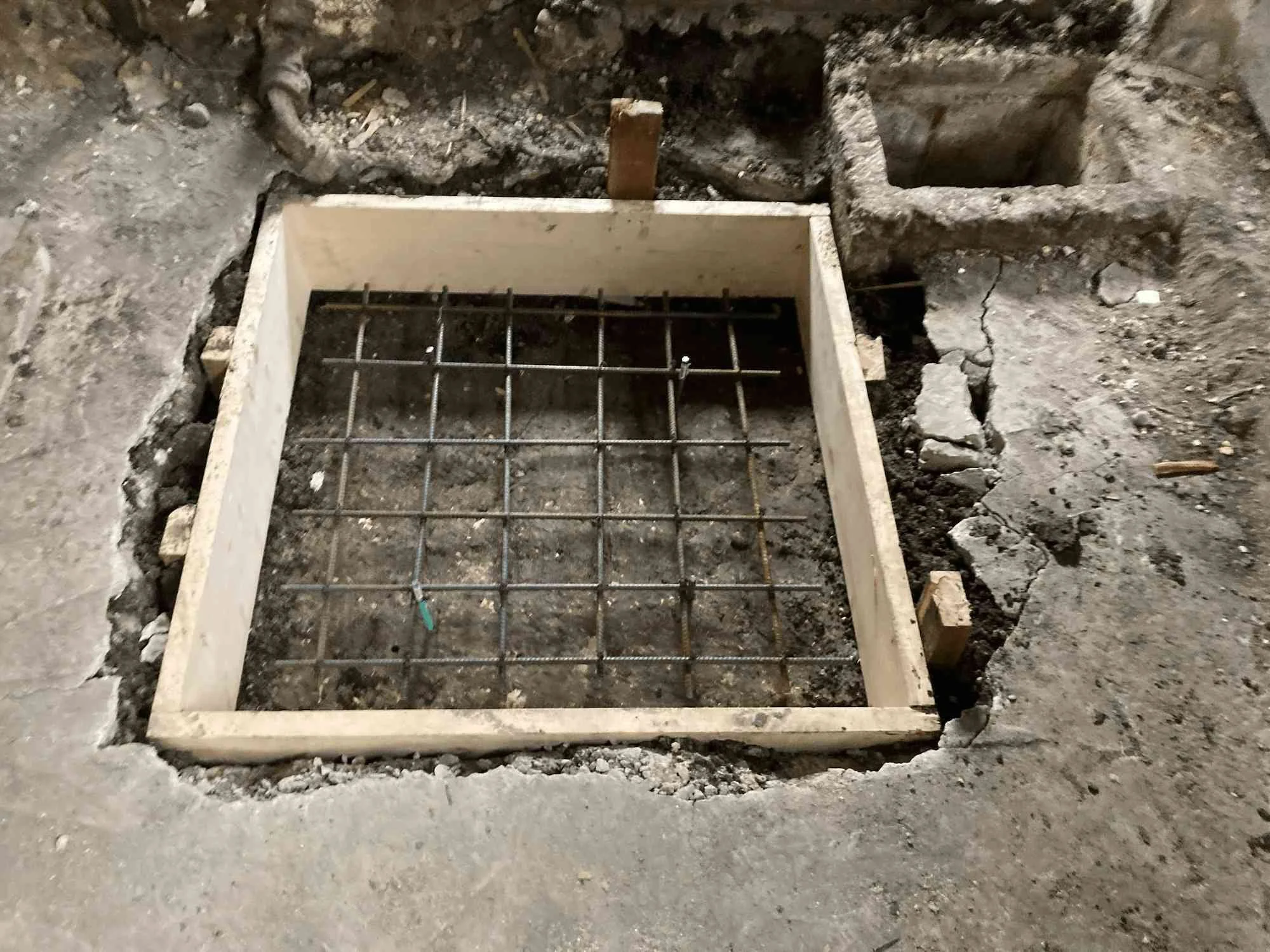 Rebar reinforcement grid in place for a new telepost concrete pad before pouring.