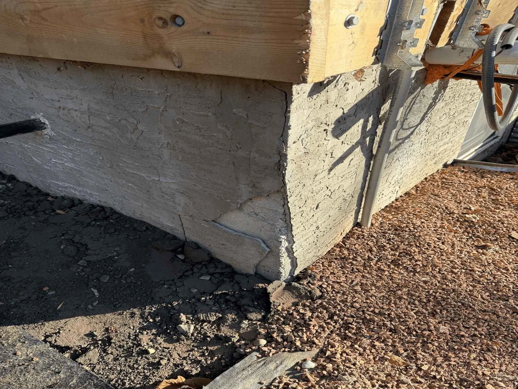 Foundation wall with parging applied to the above-grade portion for weather protection and a finished appearance.