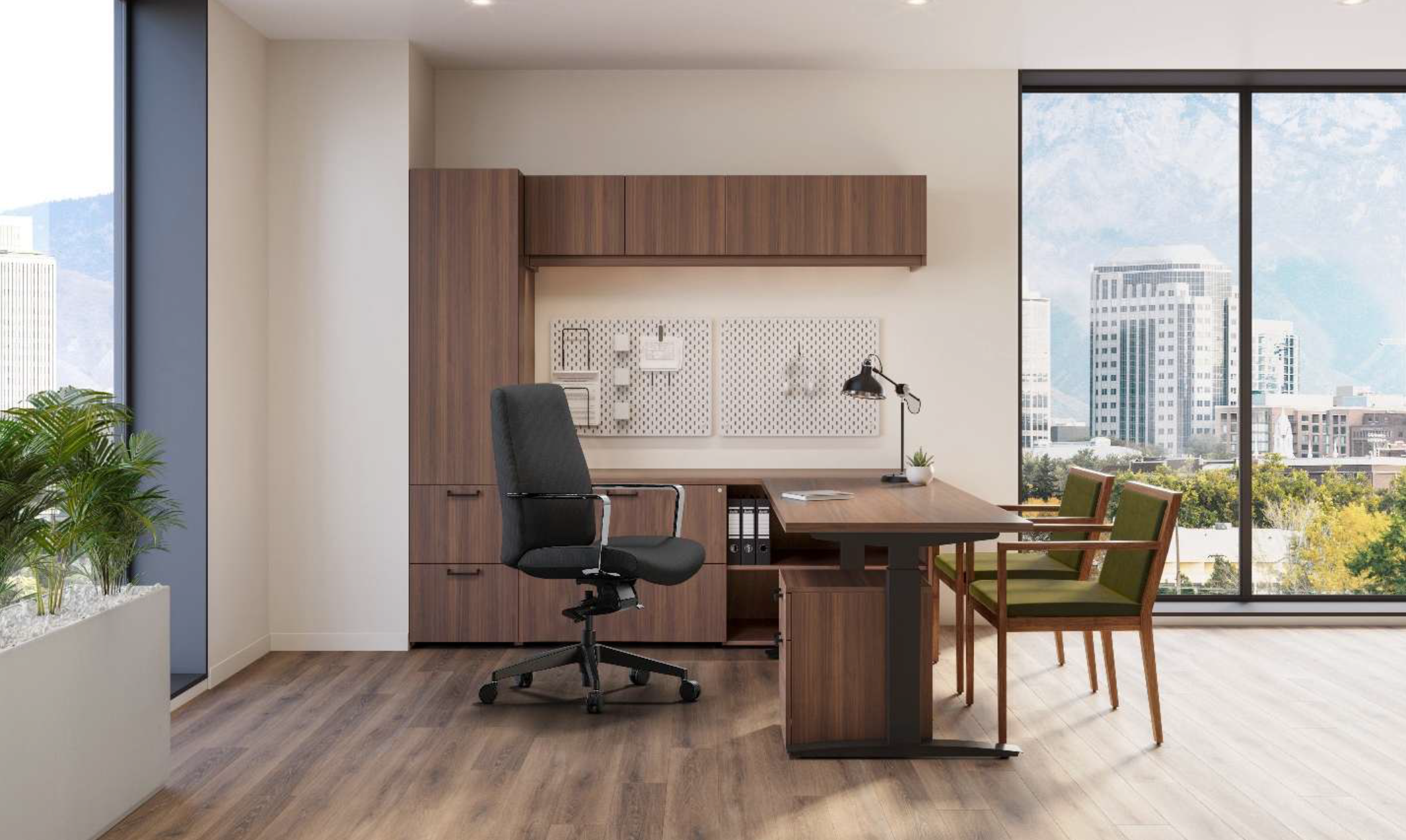 Modern office space with wooden desk, black ergonomic chair, green upholstered chairs, large windows showing cityscape, and indoor plants.