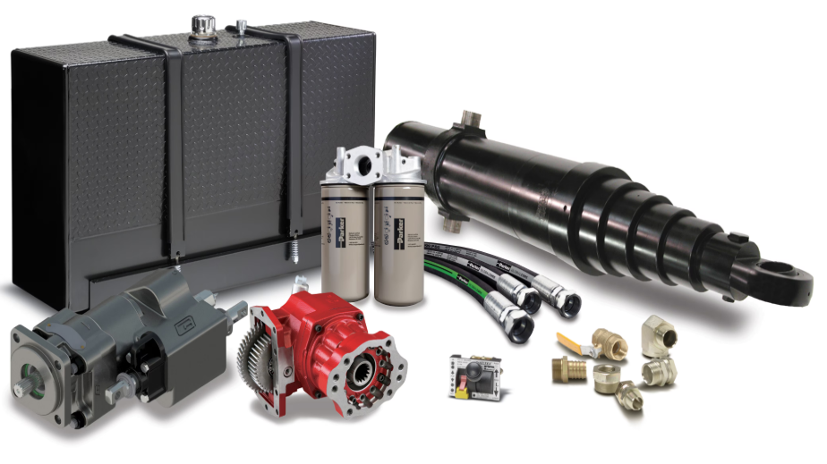 Various hydraulic and mechanical components, including a black hydraulic reservoir, filters, a rotary actuator, hoses, a gear pump, fittings, and a control valve.
