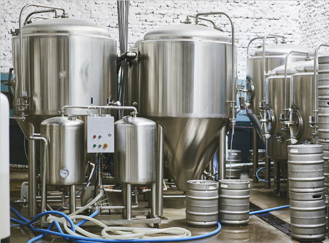 Industrial brewing or fermentation tanks in a brewery or biotech facility.
